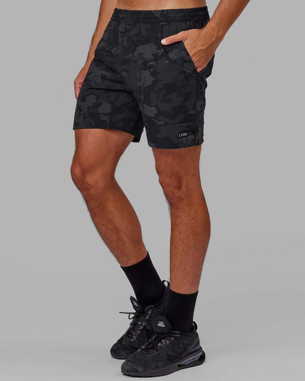 Model wearing Intensity 7" Performance Short - Black-Camo