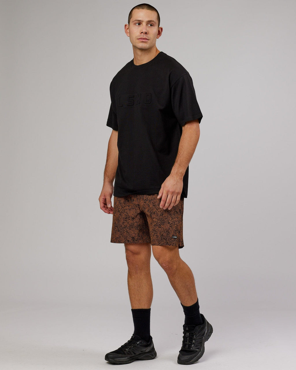 Model wearing Intensity 7" Performance Short - Agile Camel Print