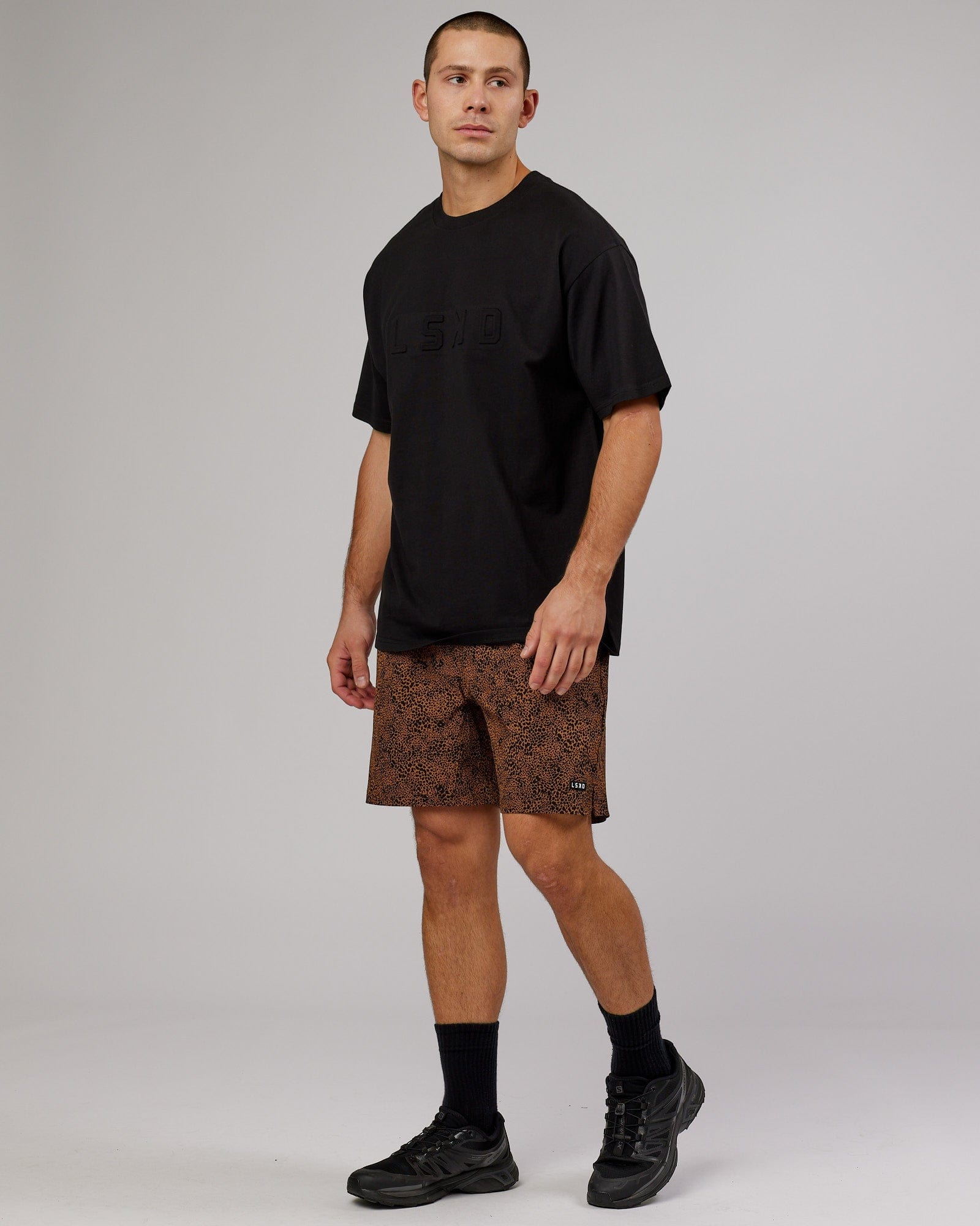 Model wearing Intensity 7" Performance Short - Agile Camel Print