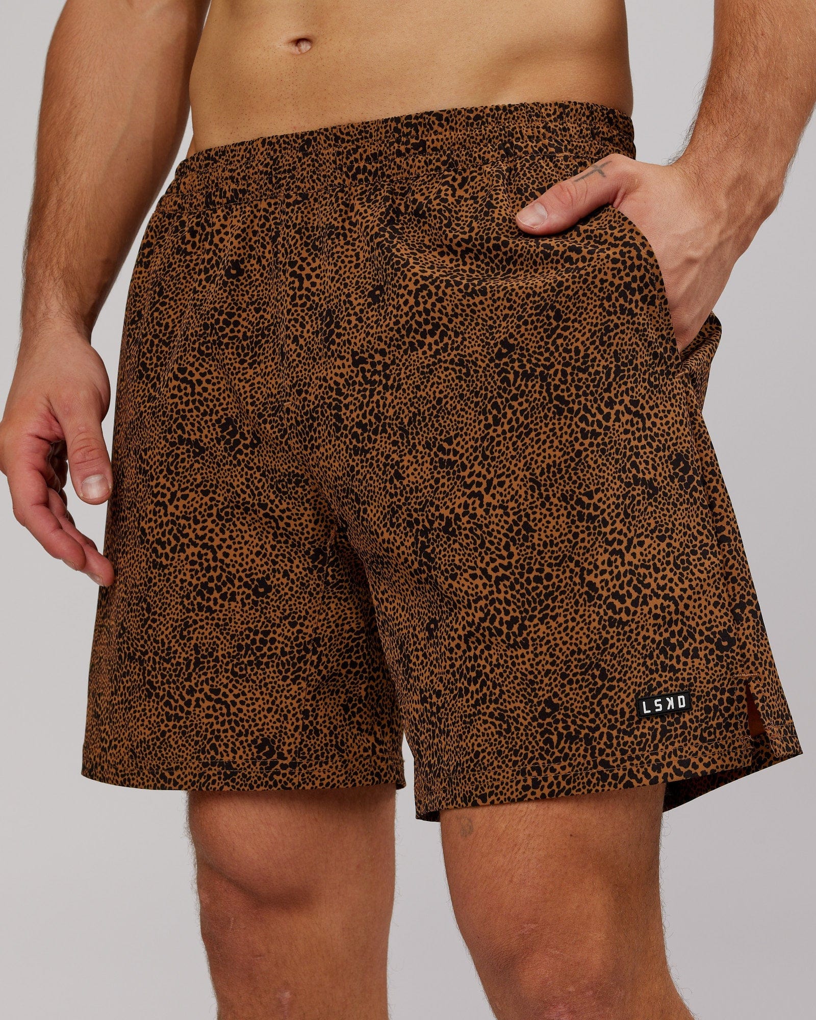 Model wearing Intensity 7" Performance Short - Agile Camel Print