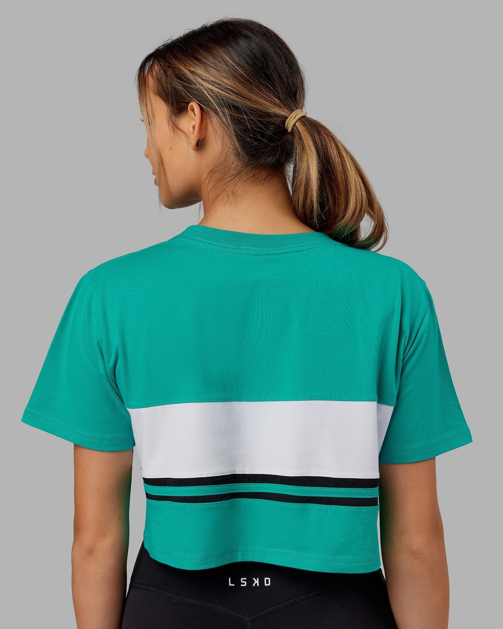 Model wearing Line-Up Cropped Tee - White-Hyper Teal