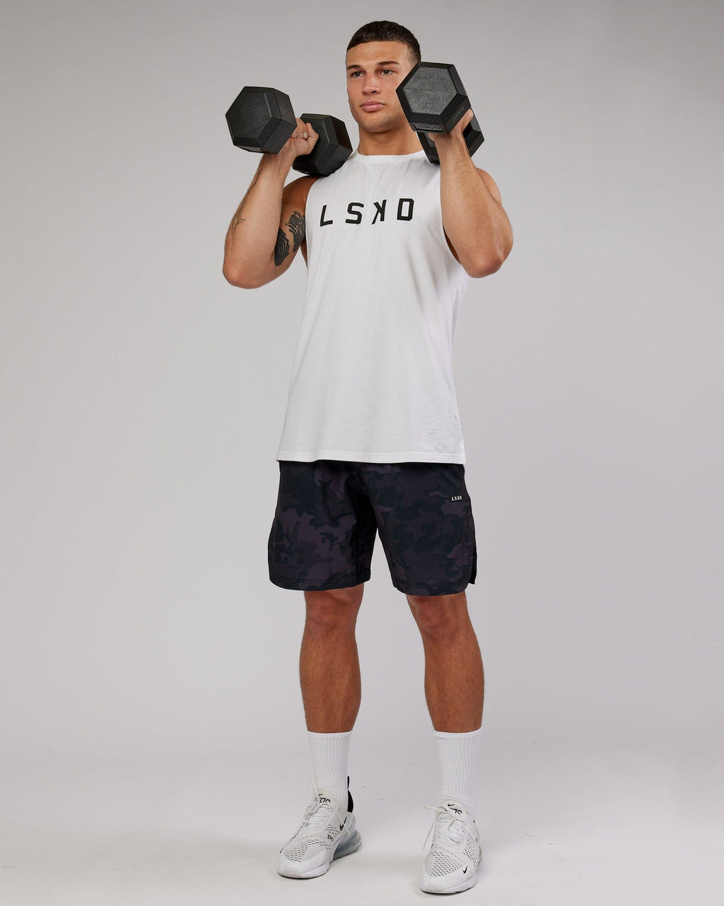 Model wearing Competition 8" Performance Short - Black Camo