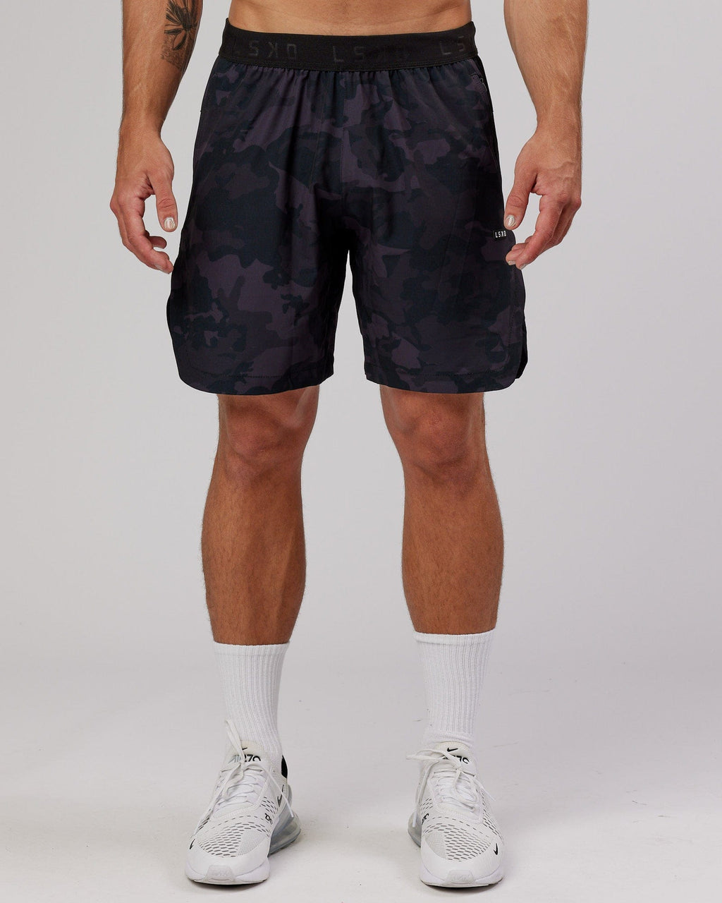Model wearing Competition 8" Performance Short - Black Camo
