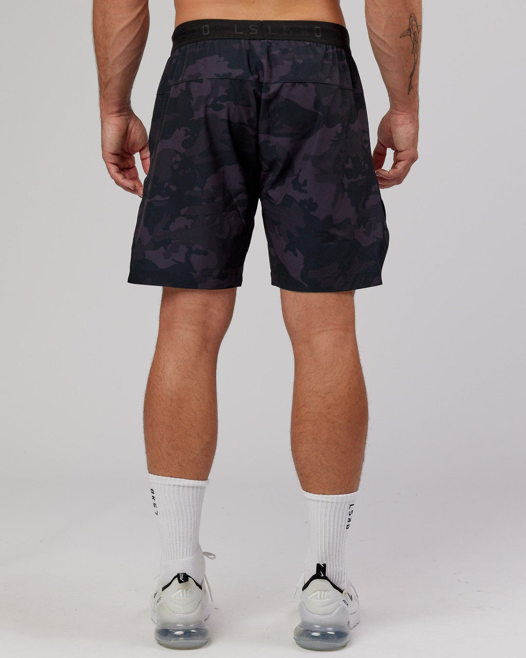 Model wearing Competition 8" Performance Short - Black Camo