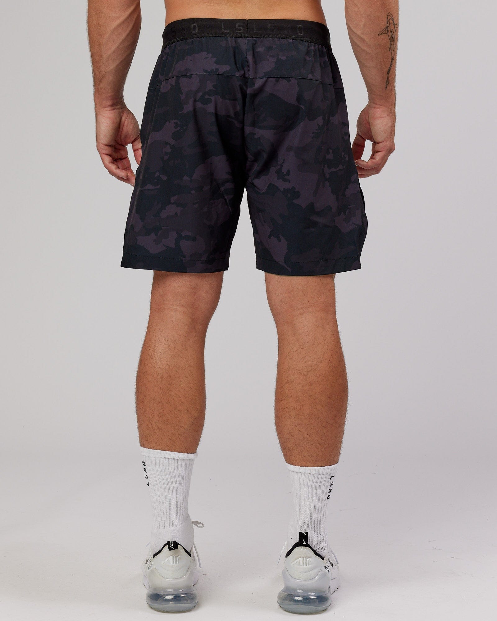 Model wearing Competition 8" Performance Short - Black Camo