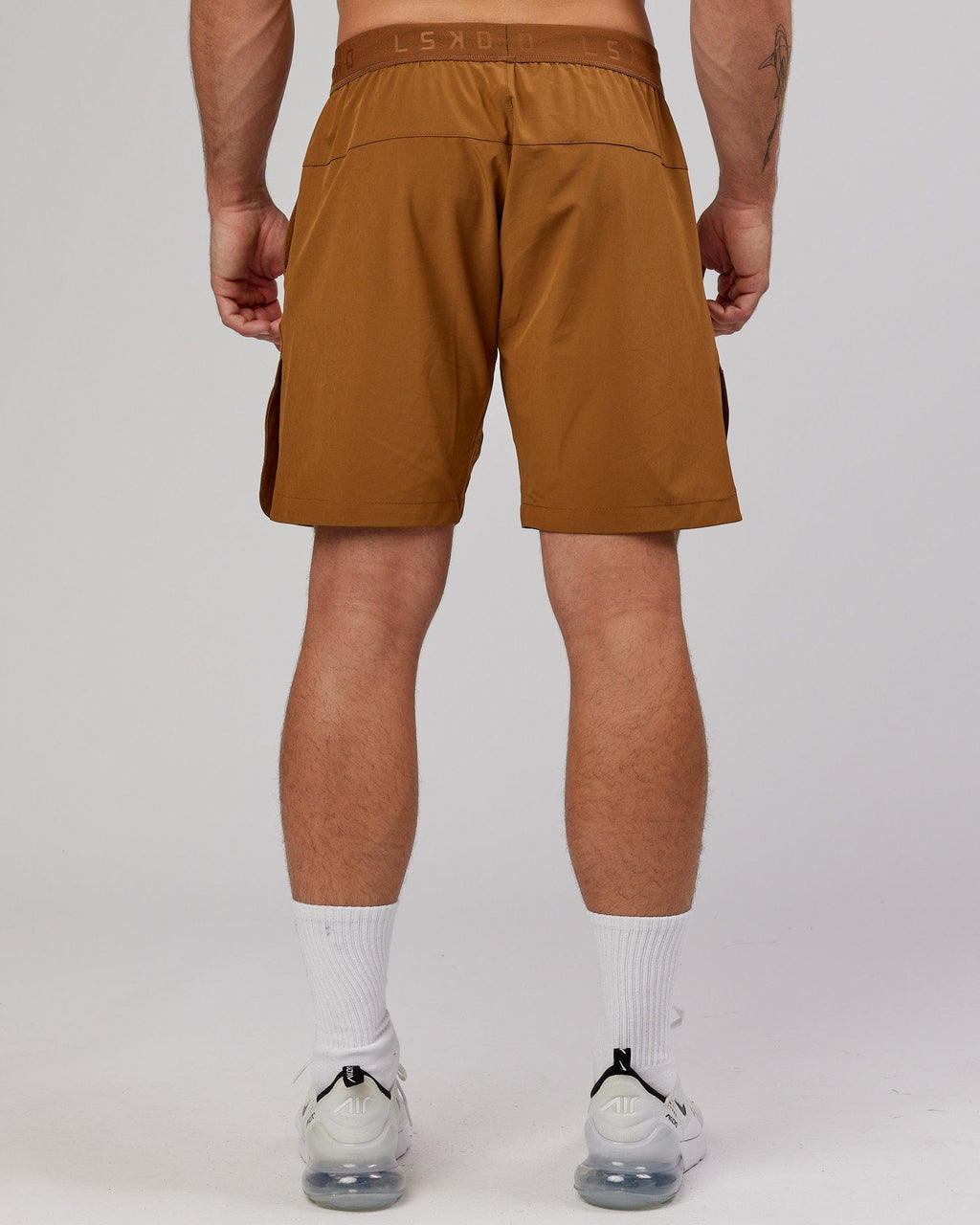 Model wearing Competition 8" Performance Short - Camel