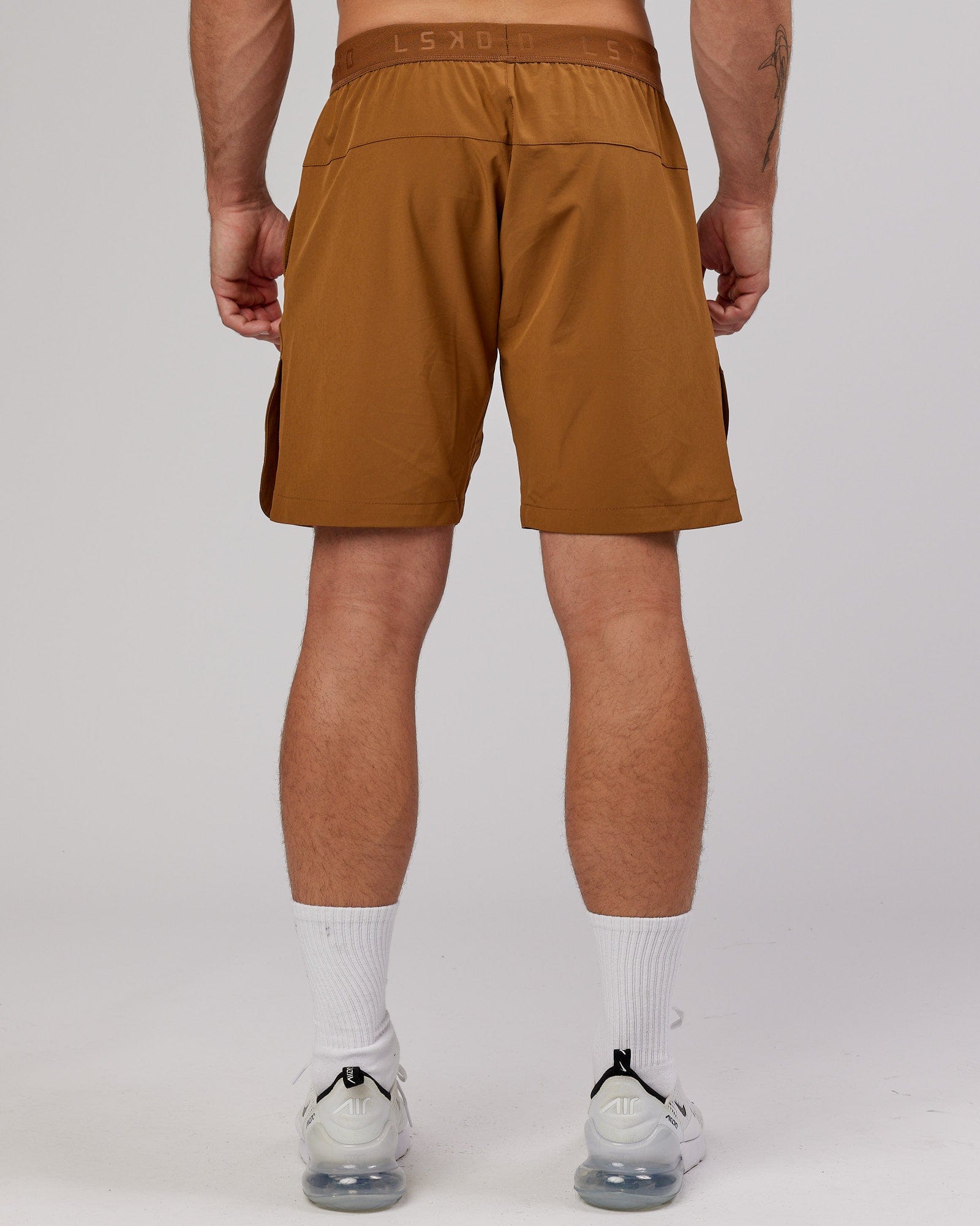 Model wearing Competition 8" Performance Short - Camel