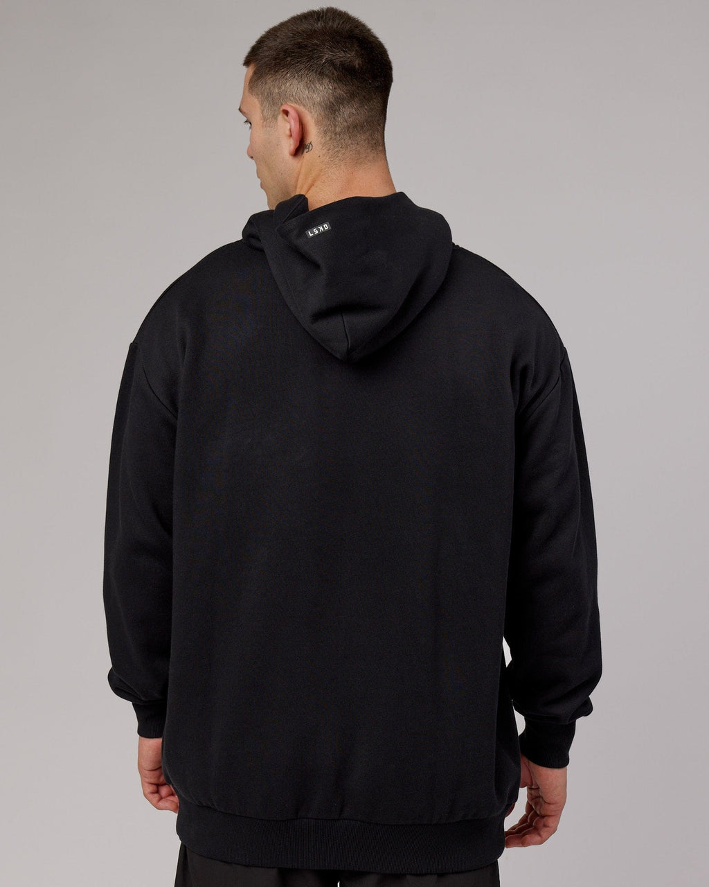 Model wearing Capsule Hoodie Oversize - Black