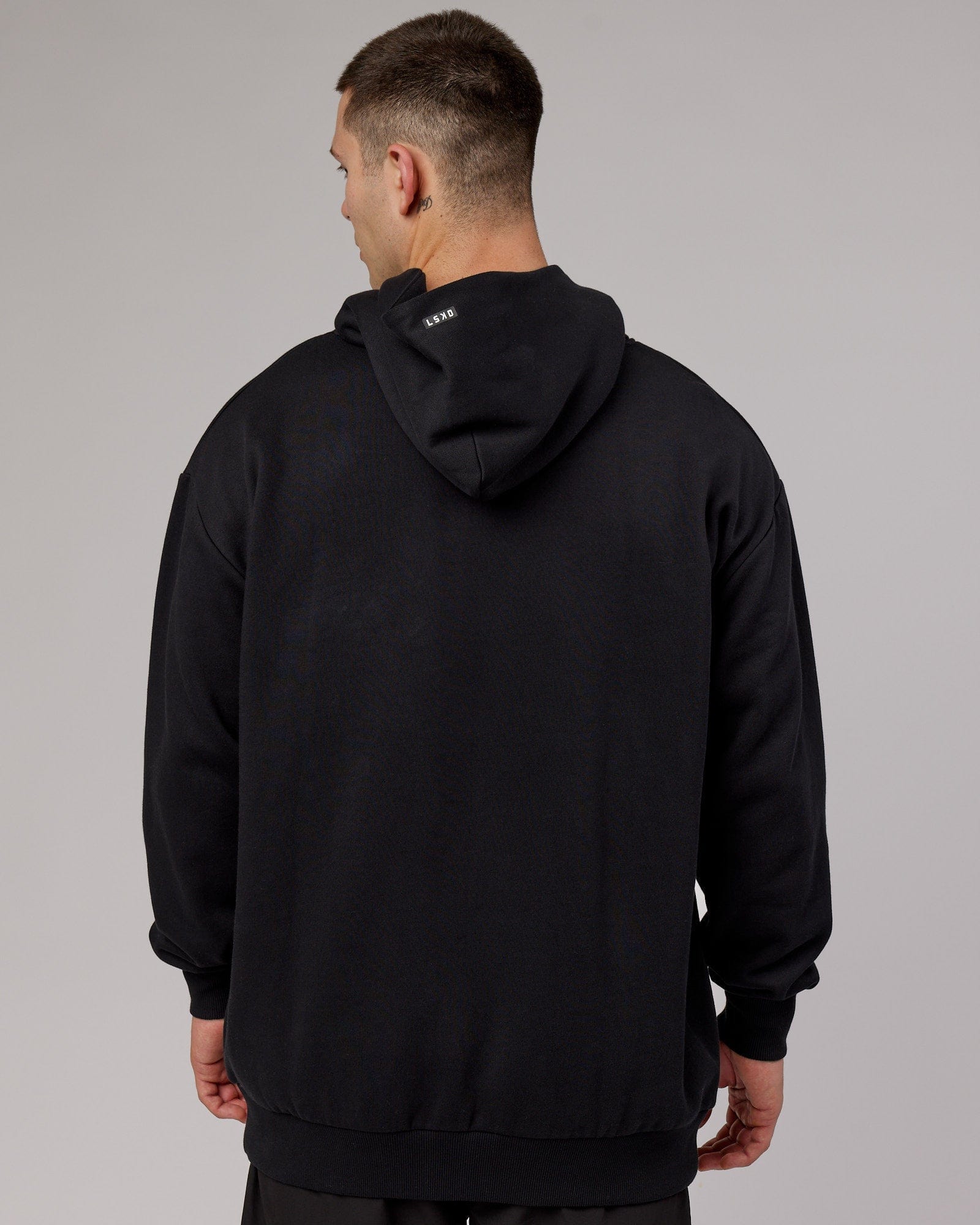Model wearing Capsule Hoodie Oversize - Black