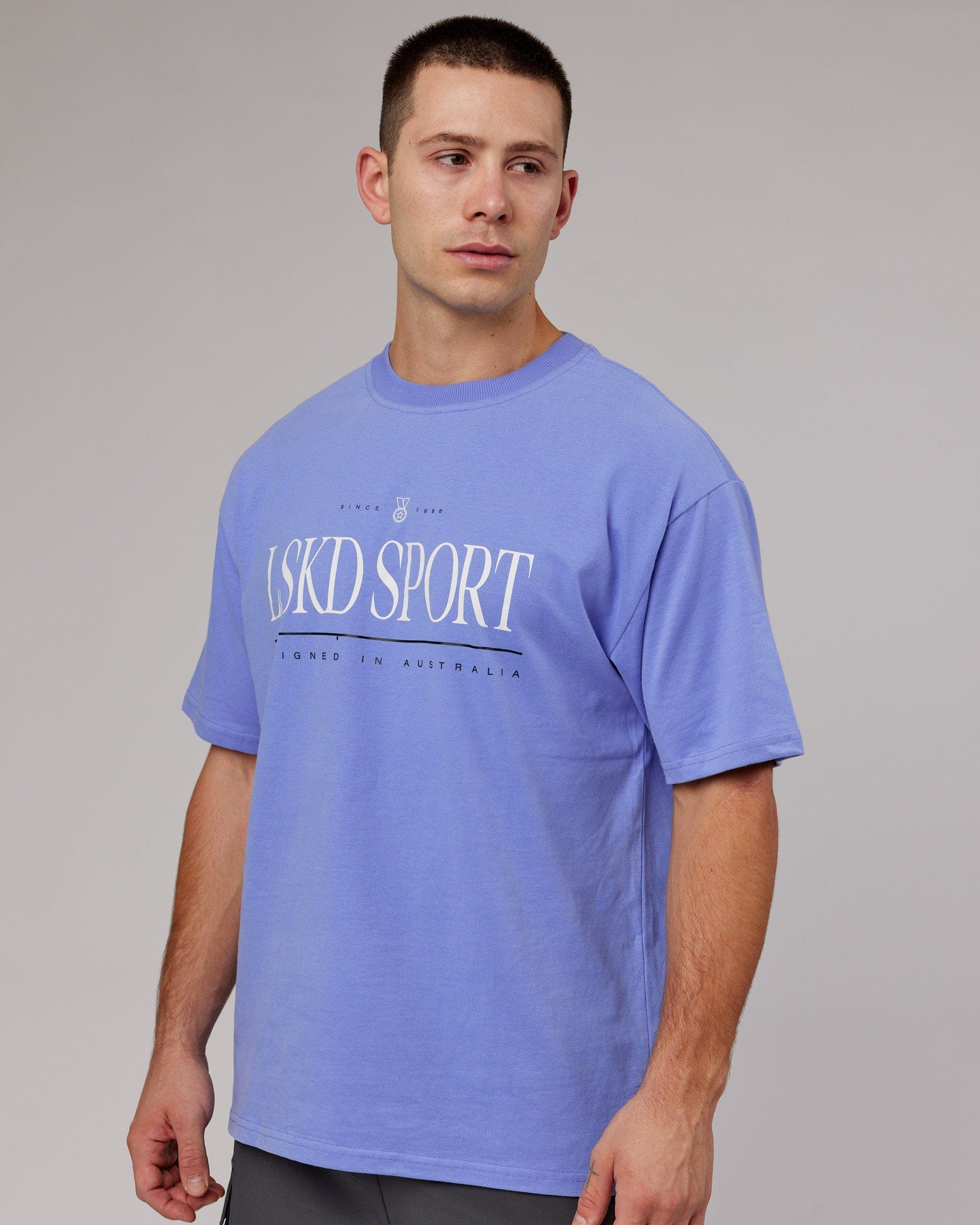 Model wearing Unisex Heritage Heavyweight Tee Oversize - Cornflower Blue