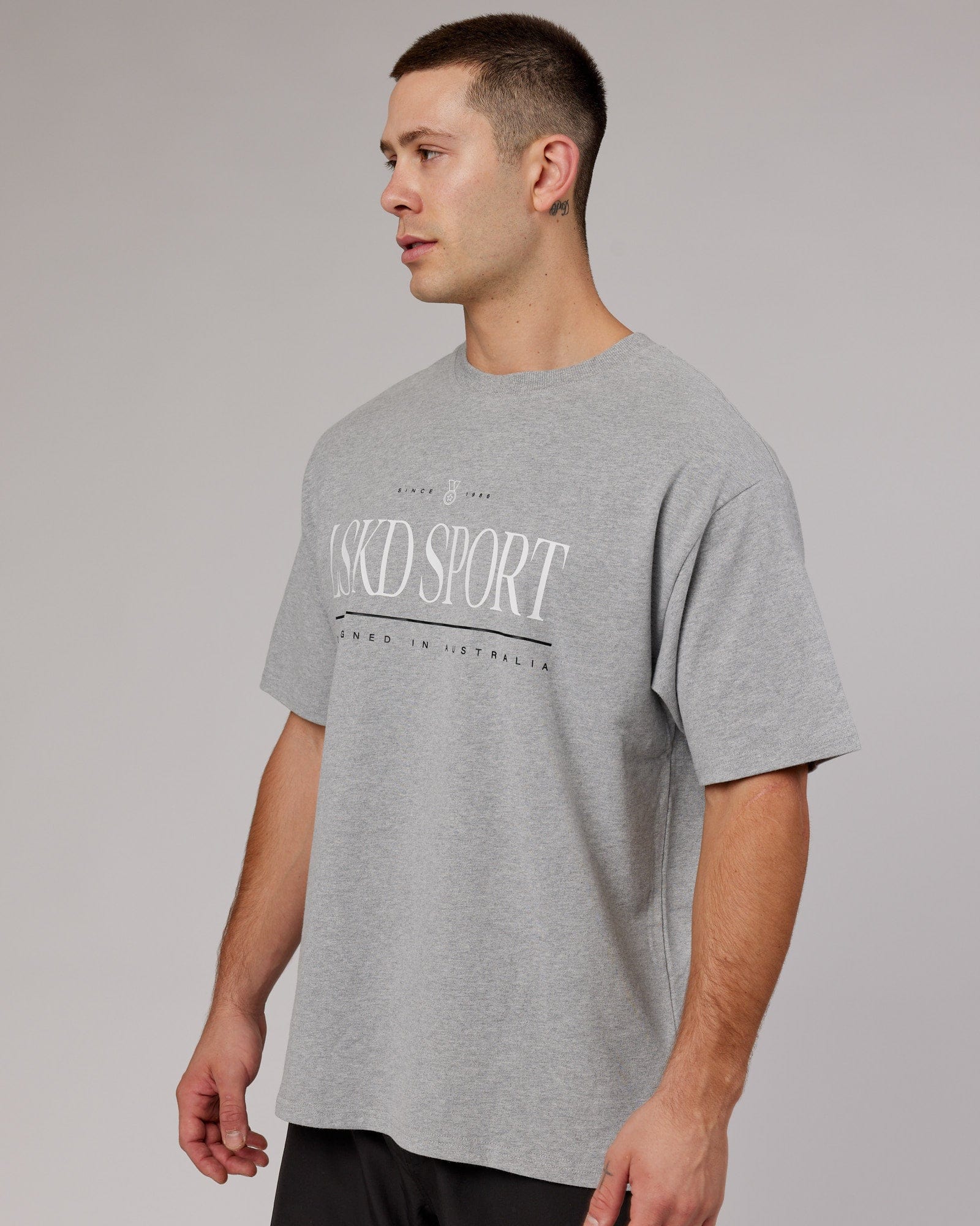 Model wearing Unisex Heritage Heavyweight Tee Oversize - Lt Grey Marl