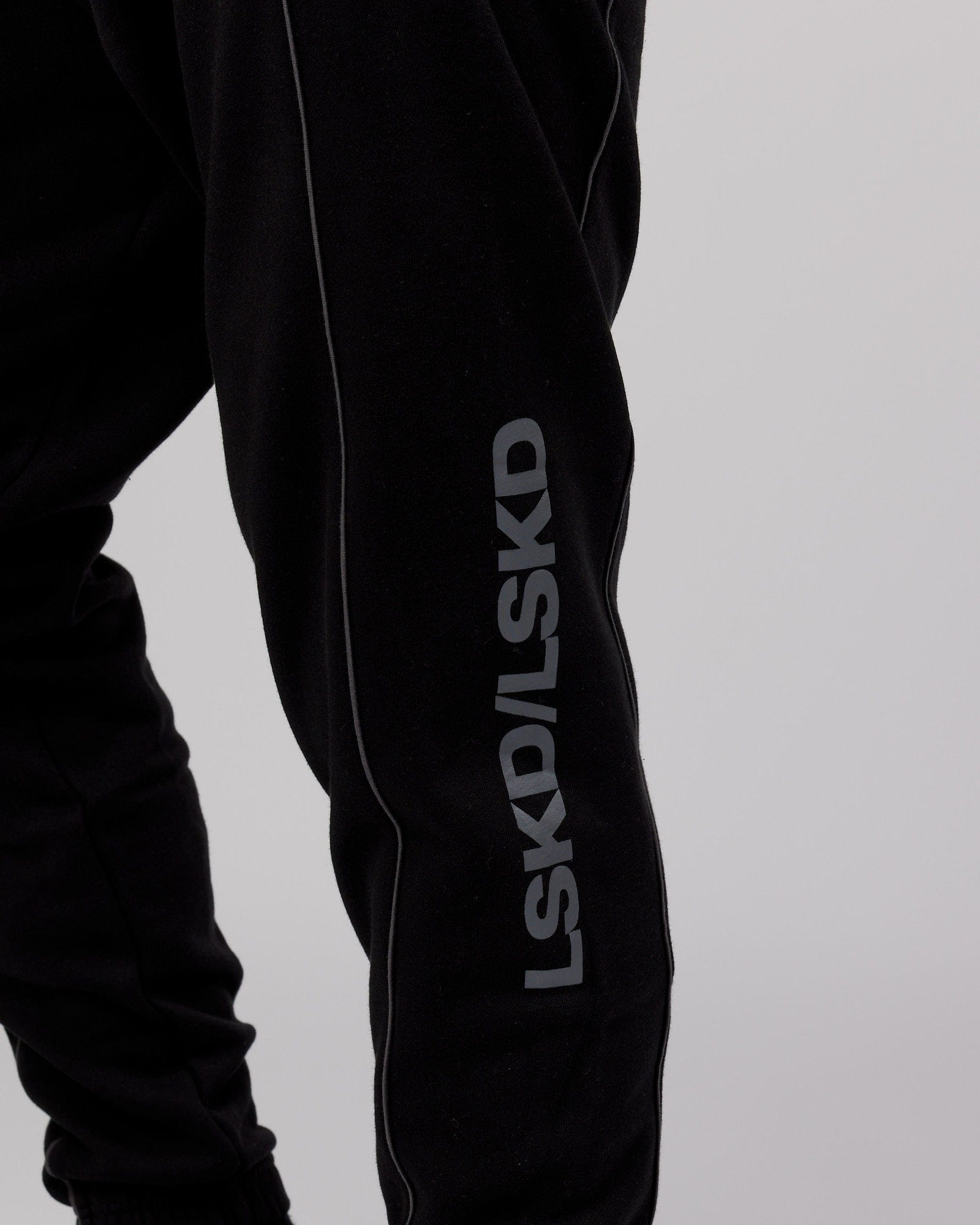 Model wearing Impact Trackpants - Black-Grey