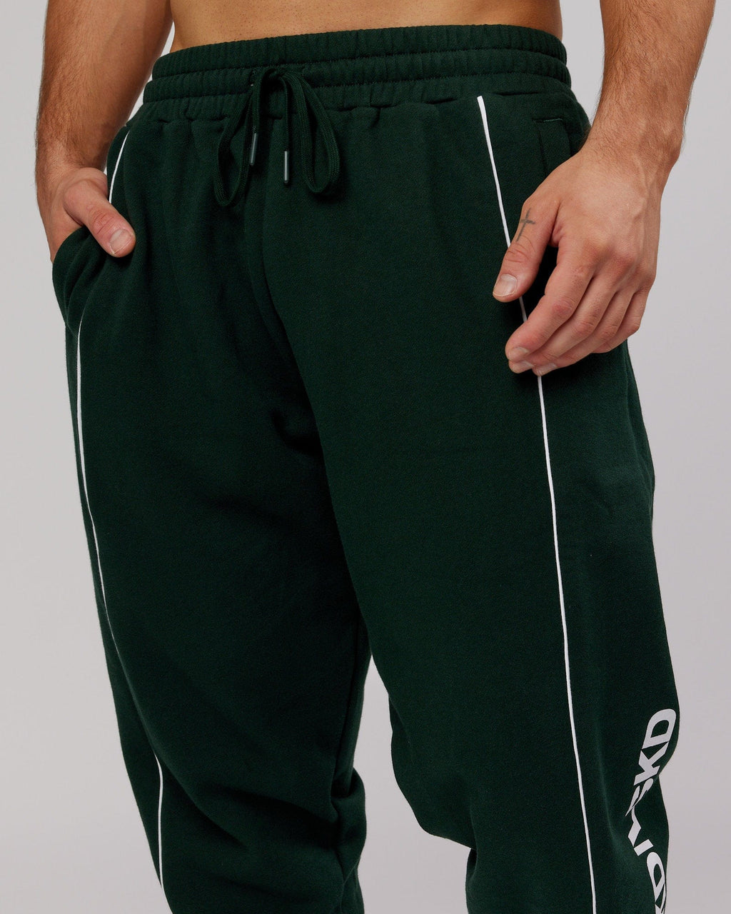 Model wearing Impact Trackpants - Forest