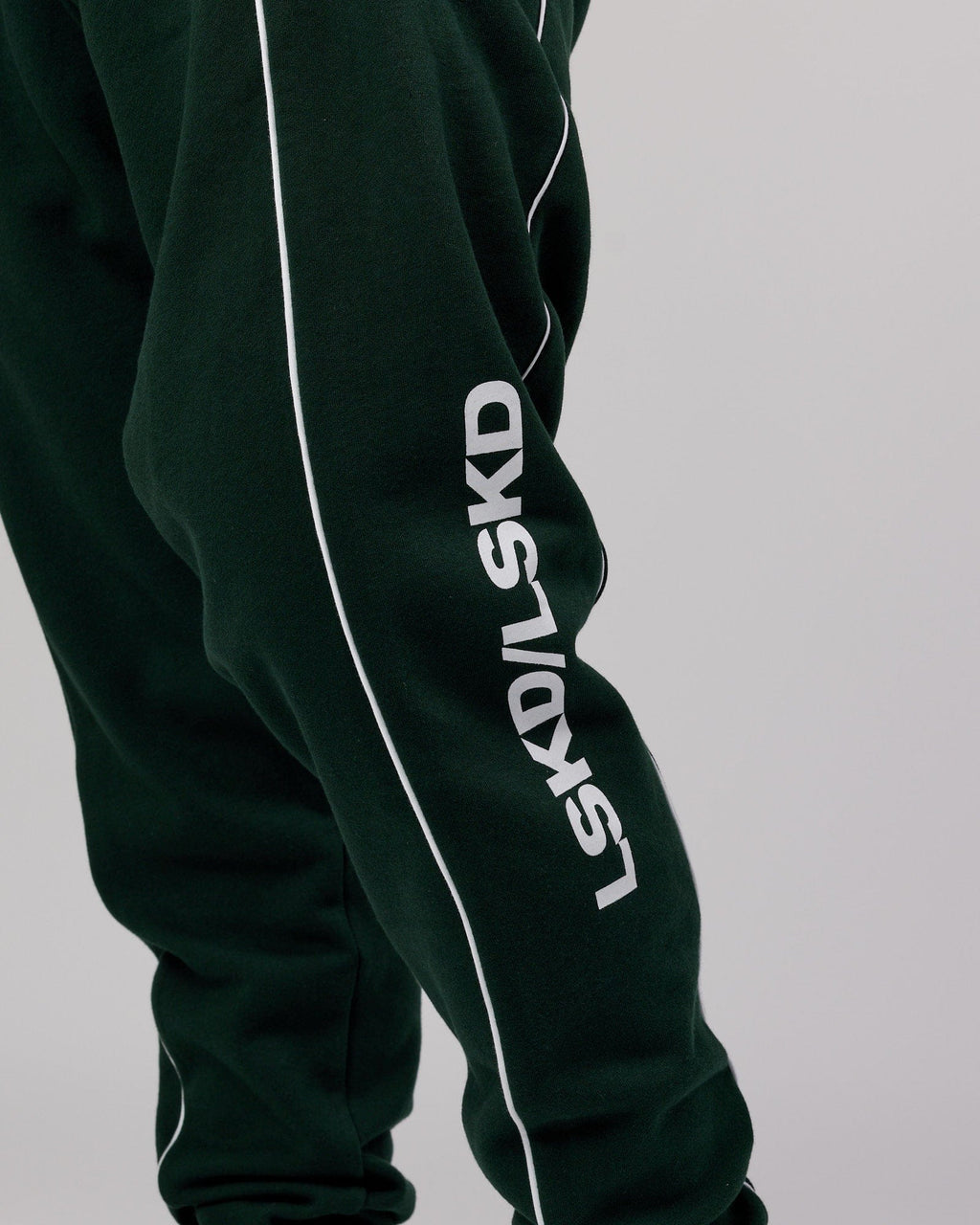 Model wearing Impact Trackpants - Forest