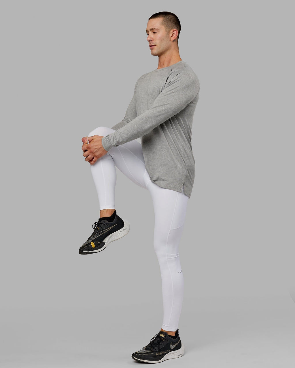 Model wearing Men's Perform Full Length Tight - White