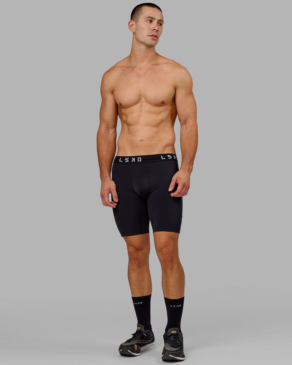 Model wearing Men's Perform Short Tight - Black