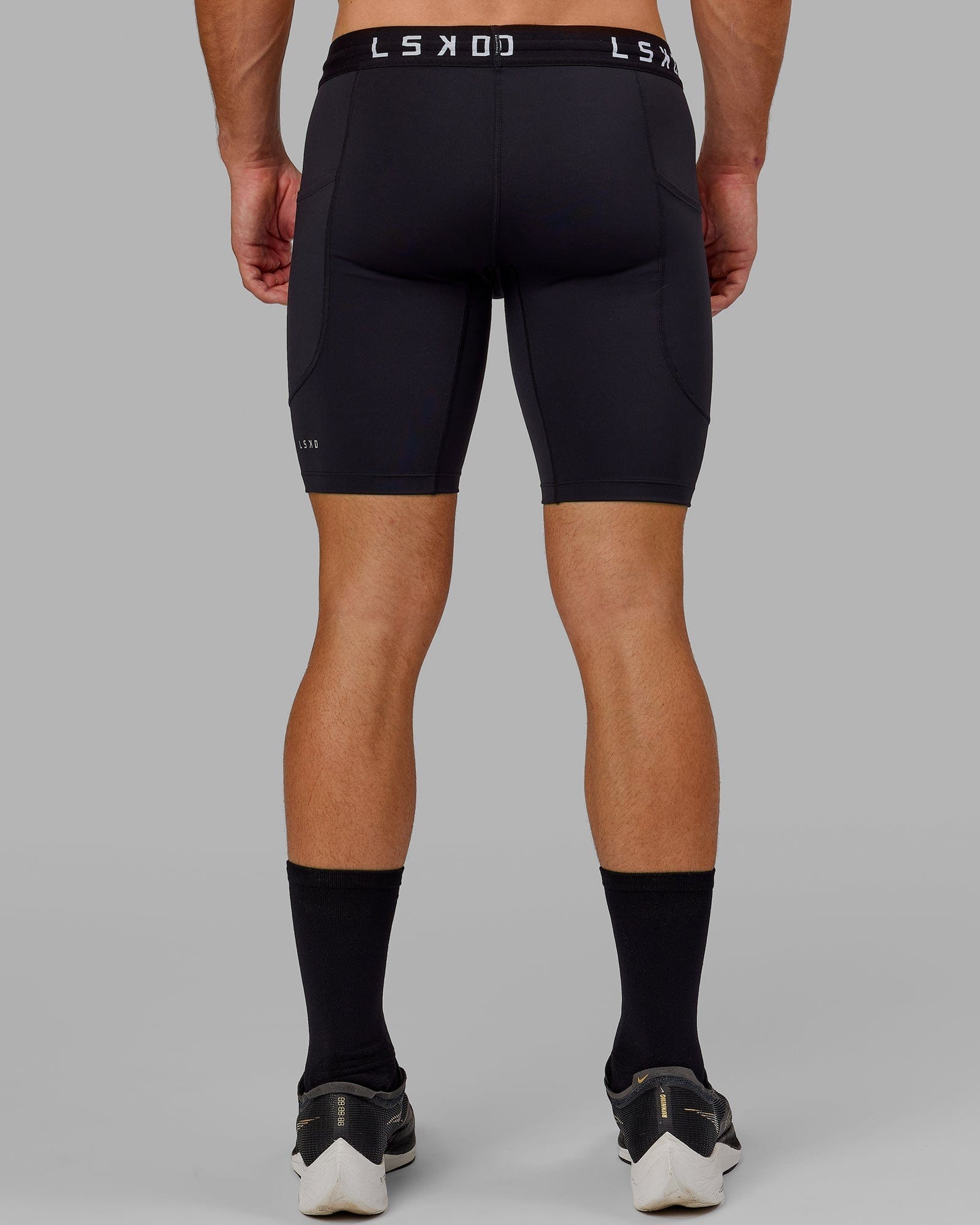 Model wearing Men's Perform Short Tight - Black