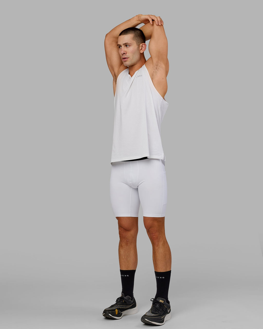 Model wearing Men's Perform Short Tight - White