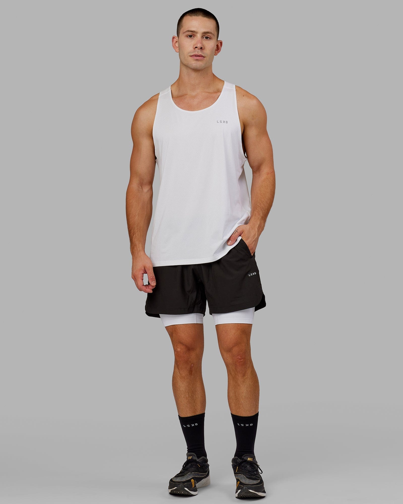 Model wearing Men's Perform Short Tight - White