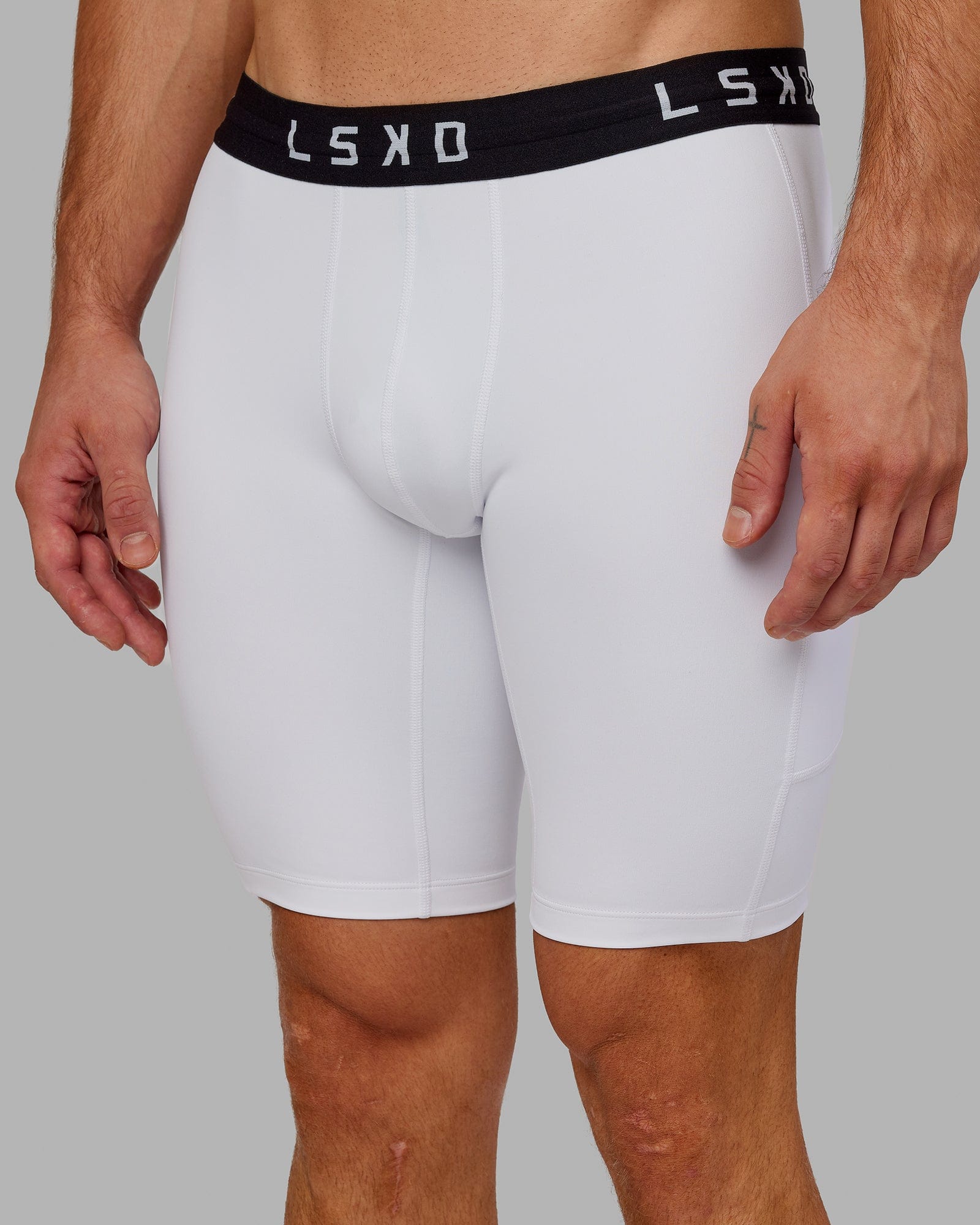 Model wearing Men's Perform Short Tight - White