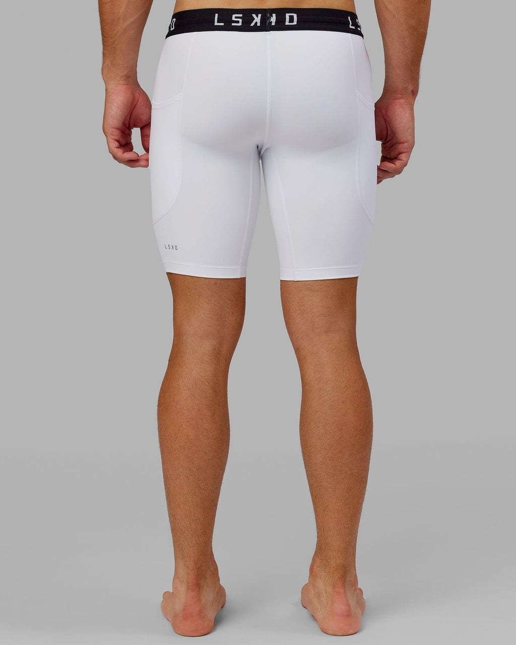 Model wearing Men's Perform Short Tight - White