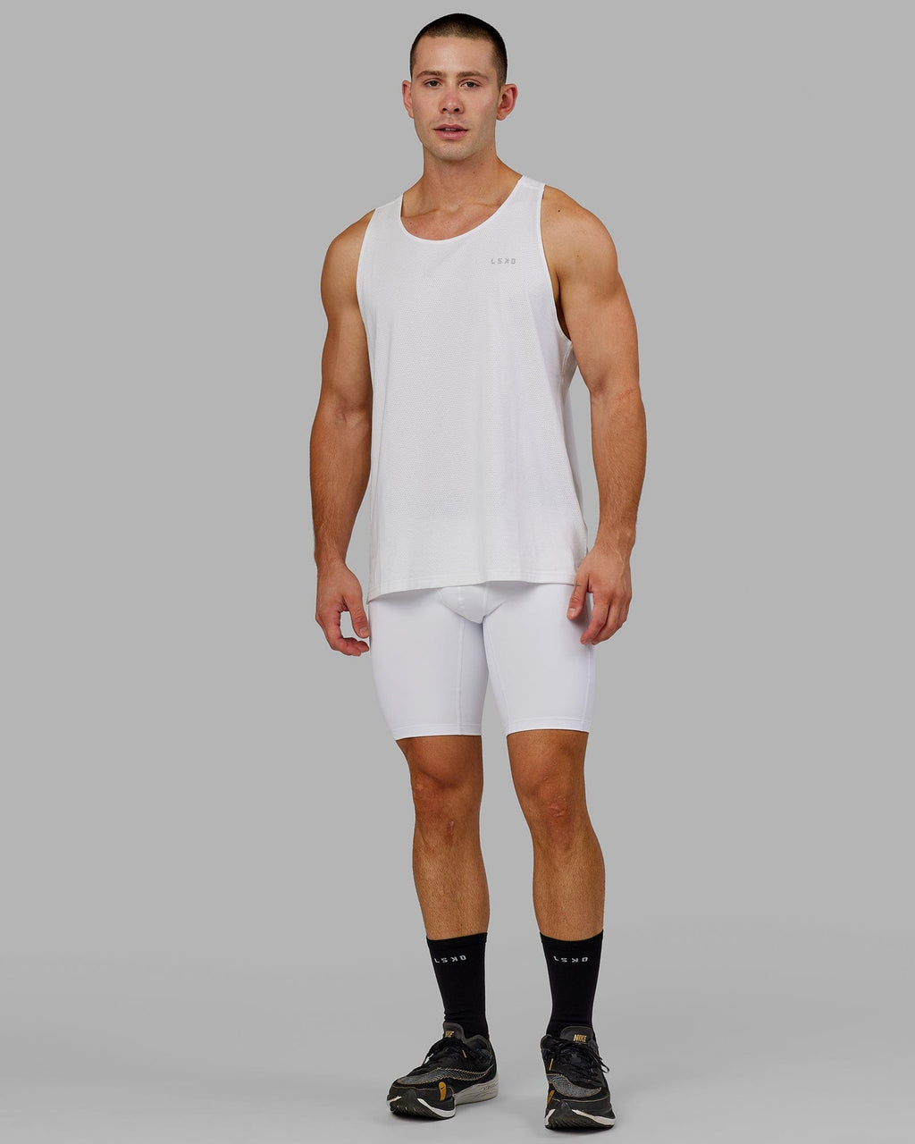 Model wearing Men's Perform Short Tight - White