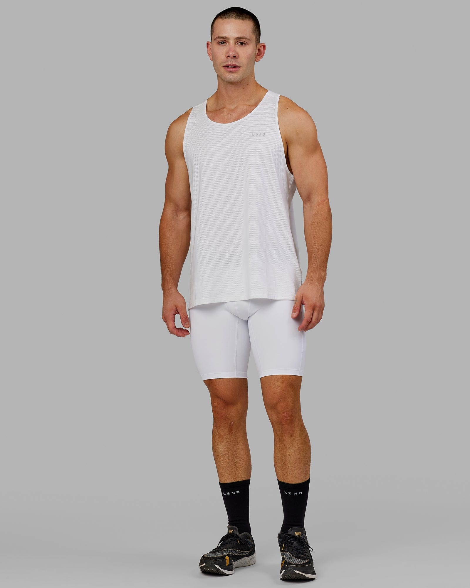 Model wearing Men's Perform Short Tight - White