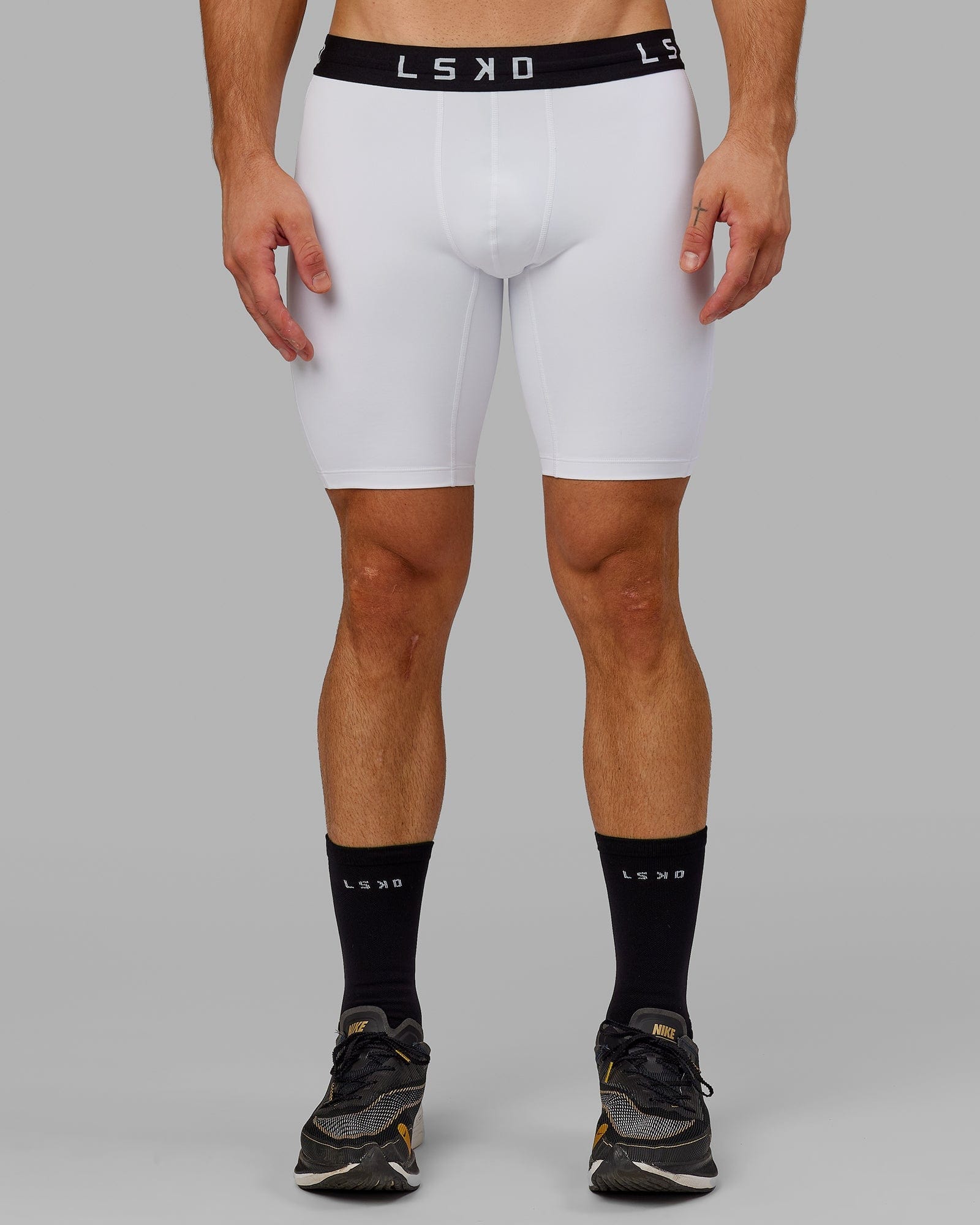 Model wearing Men's Perform Short Tight - White