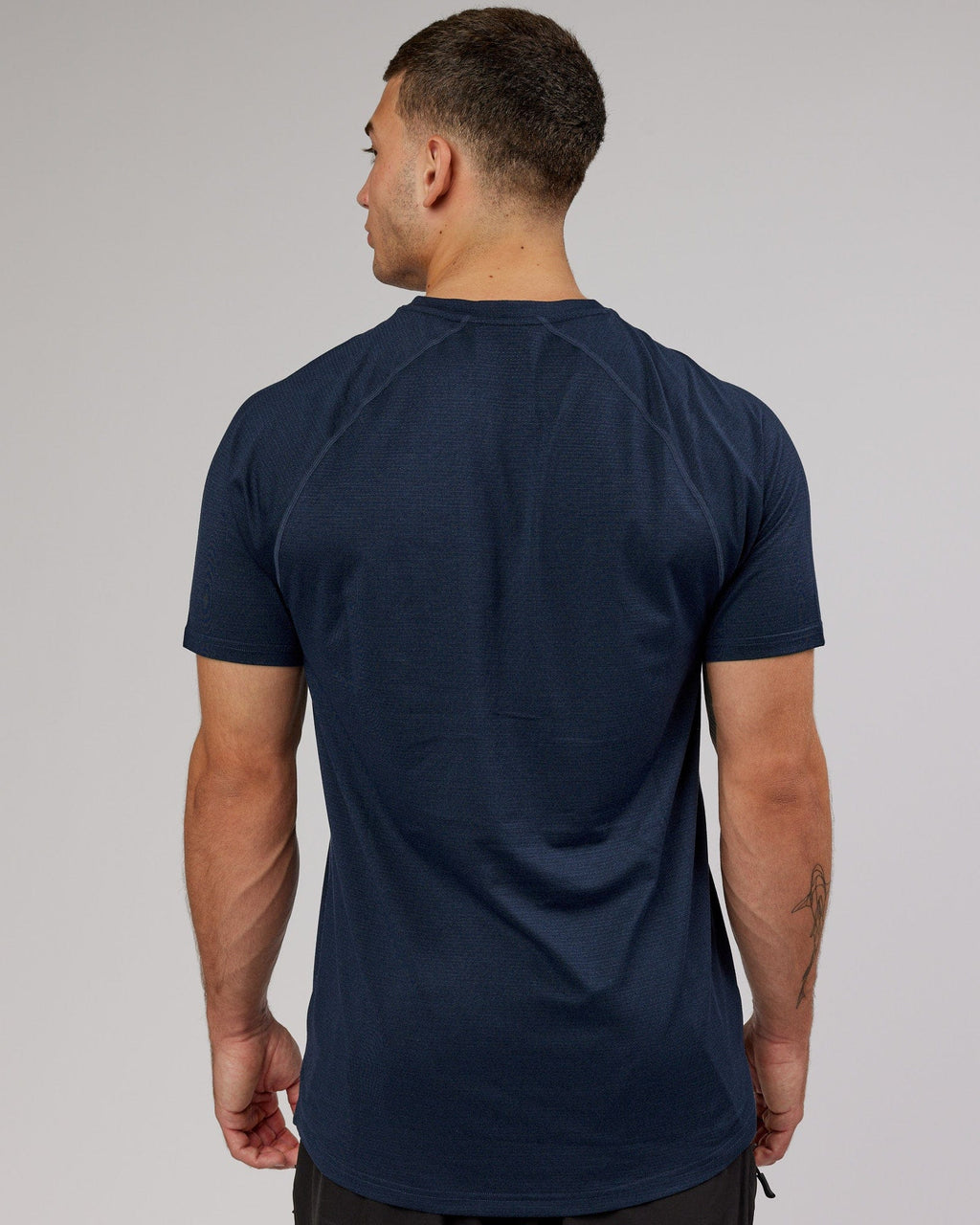 Model wearing Perform VapourFLX Tee - Navy Marl