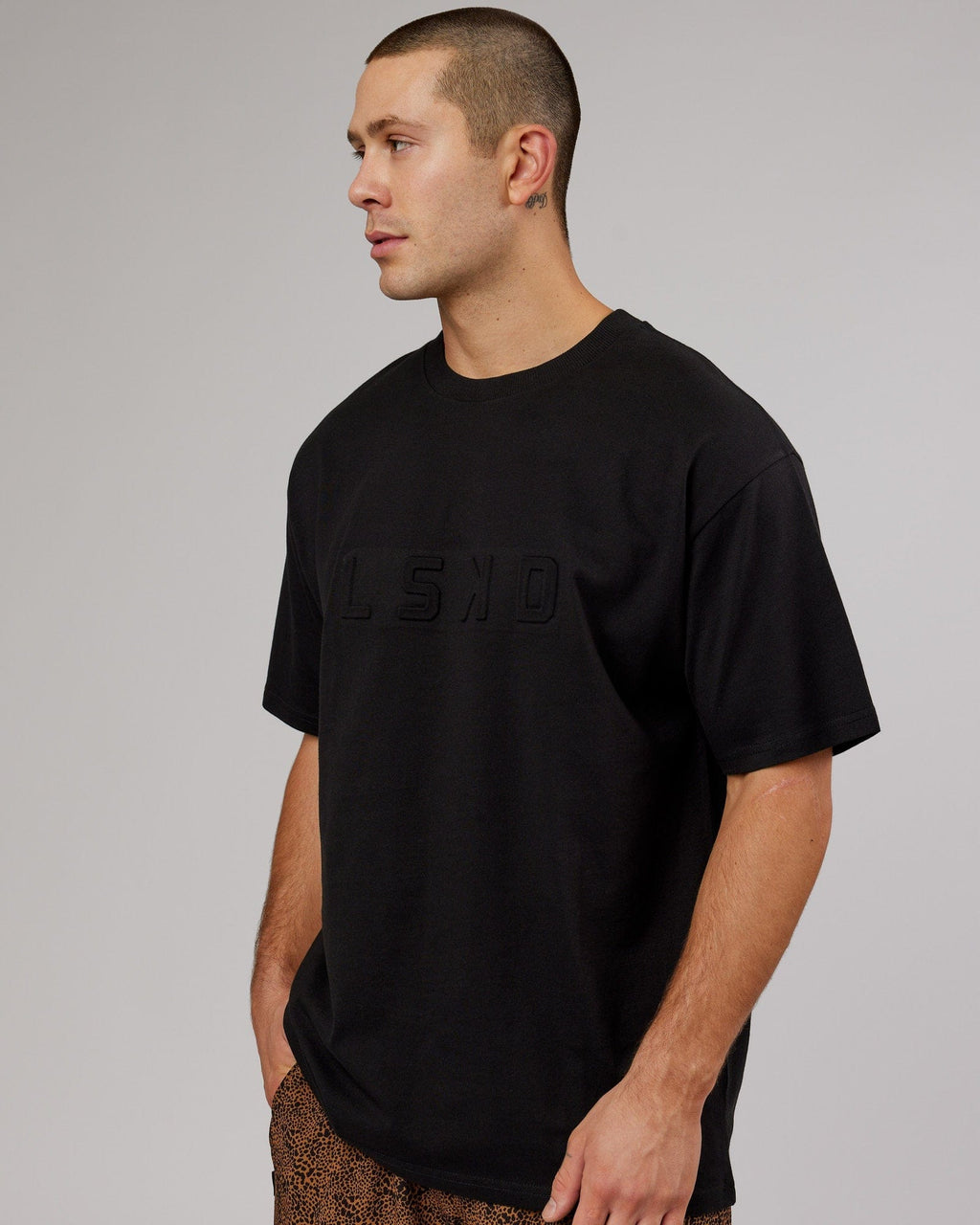 Model wearing Unisex Stamped Heavyweight Tee Oversize - Black