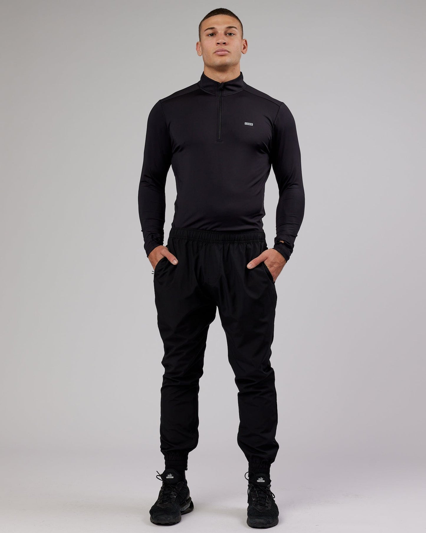 Model wearing Streamlined 1/4 Zip Active LS Top - Black