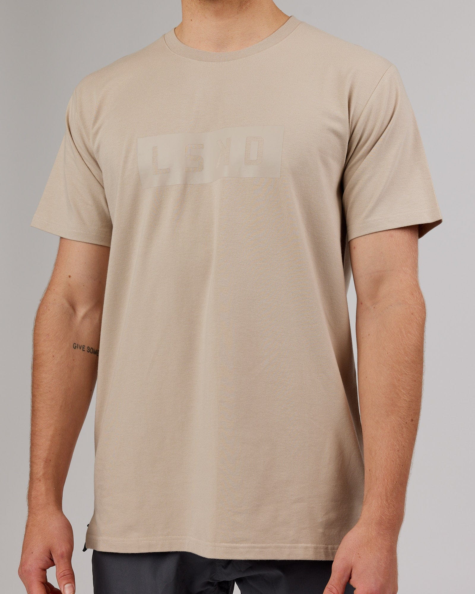 Model wearing Strength FLXDRY Performance Tee - Taupe