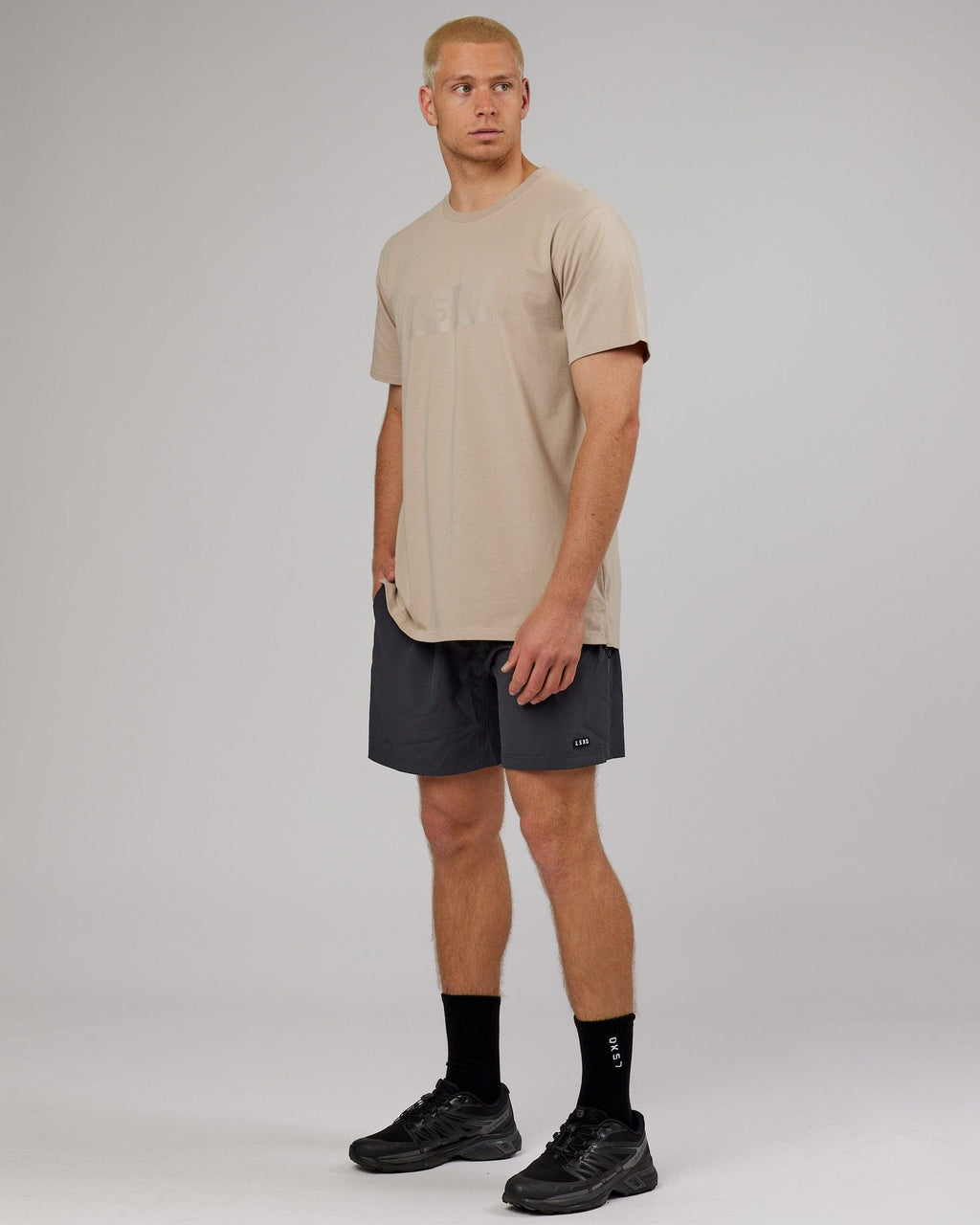 Model wearing Strength FLXDRY Performance Tee - Taupe