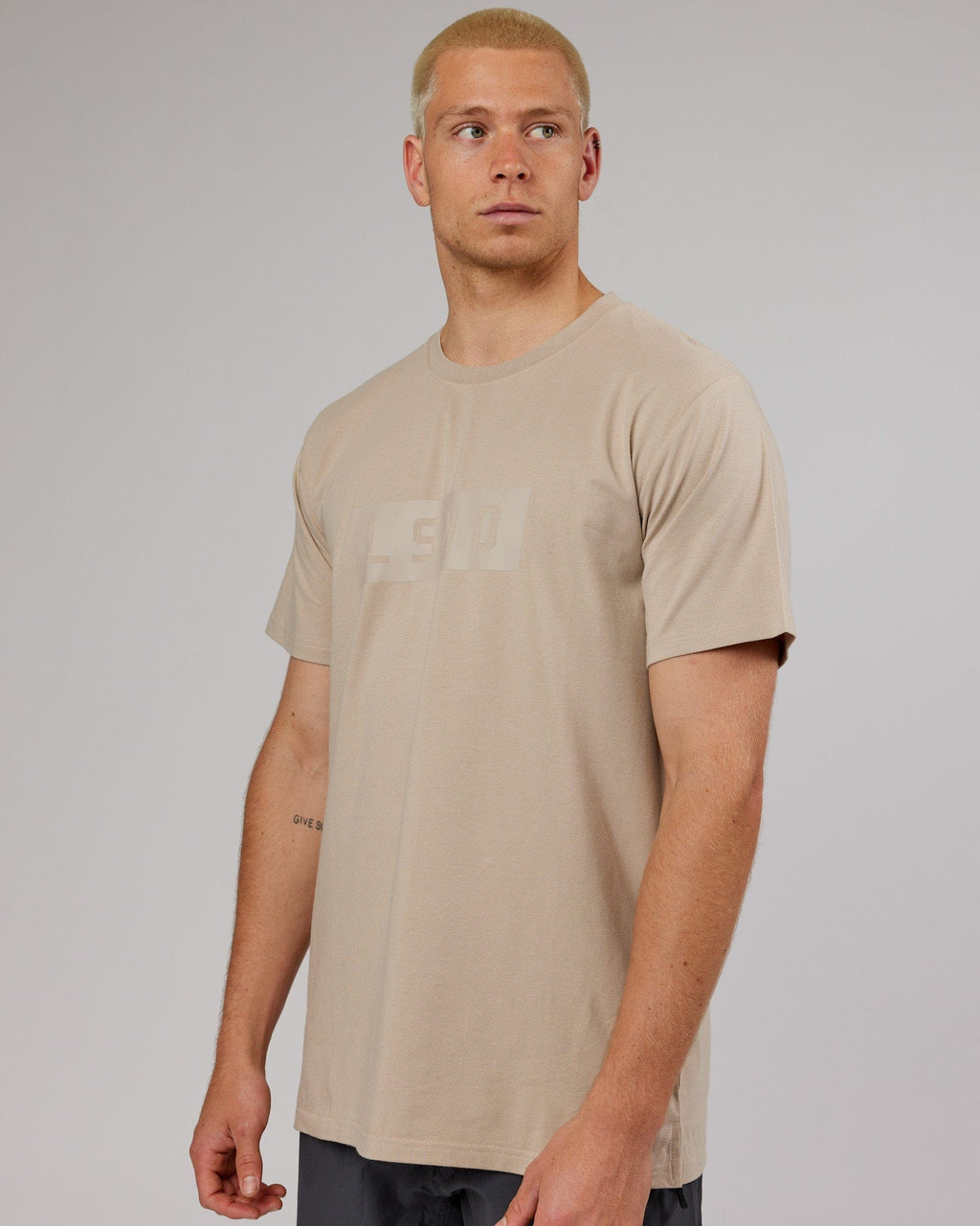Model wearing Strength FLXDRY Performance Tee - Taupe