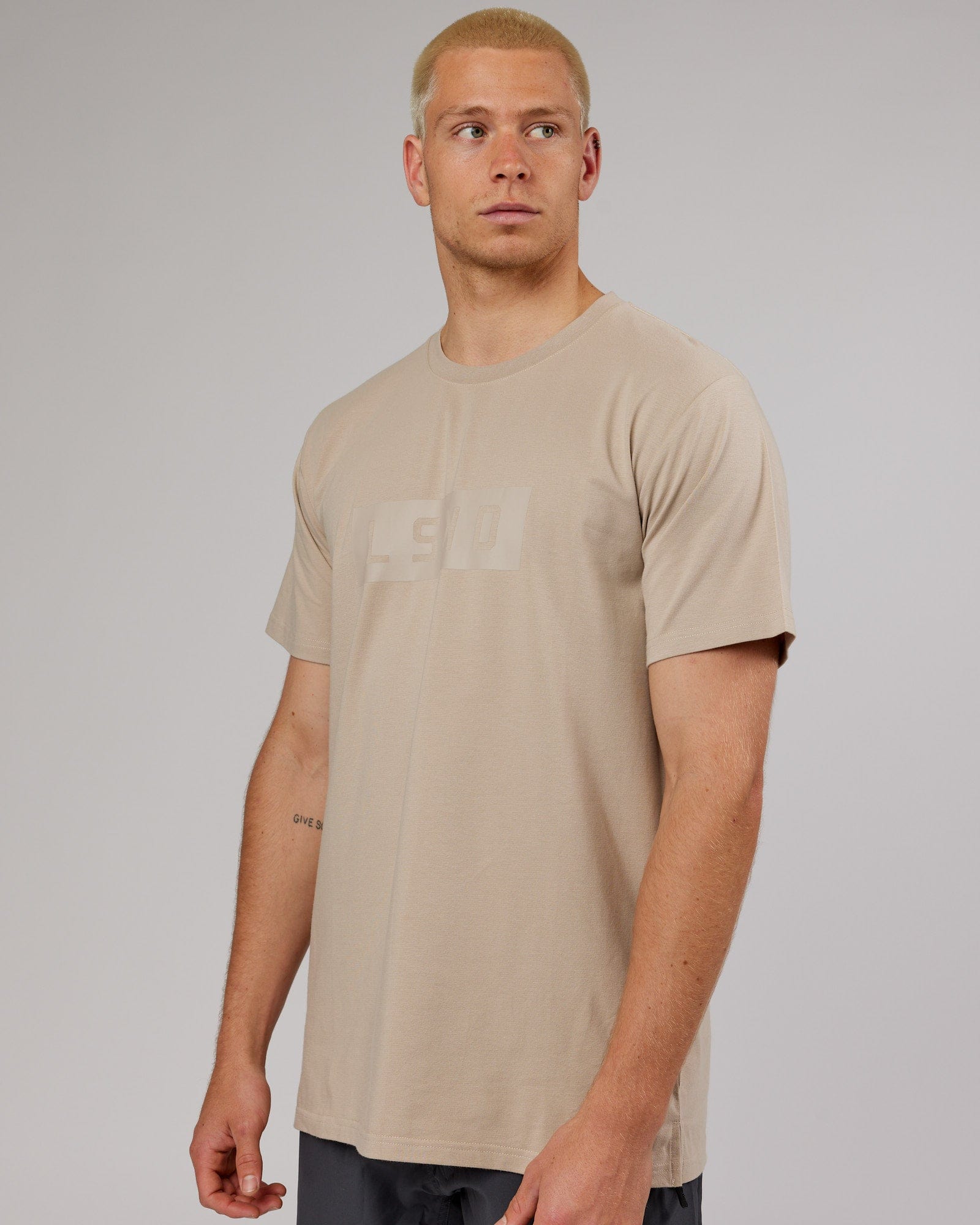 Model wearing Strength FLXDRY Performance Tee - Taupe