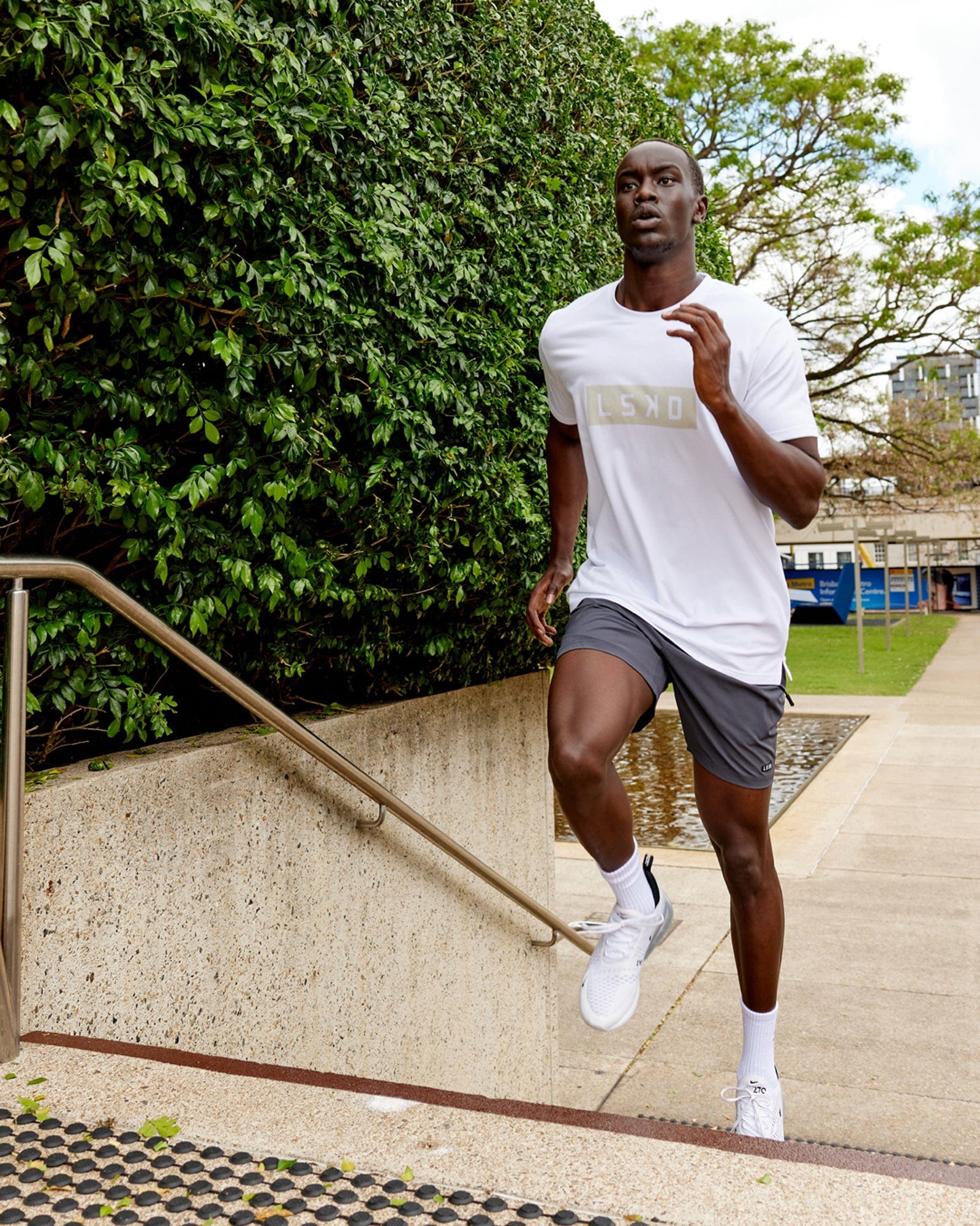 Model wearing Strength FLXDRY Performance Tee - White-Taupe