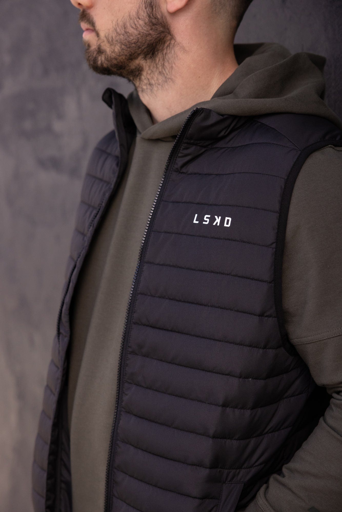 Model wearing Uplift Puffer Vest - Black Fade