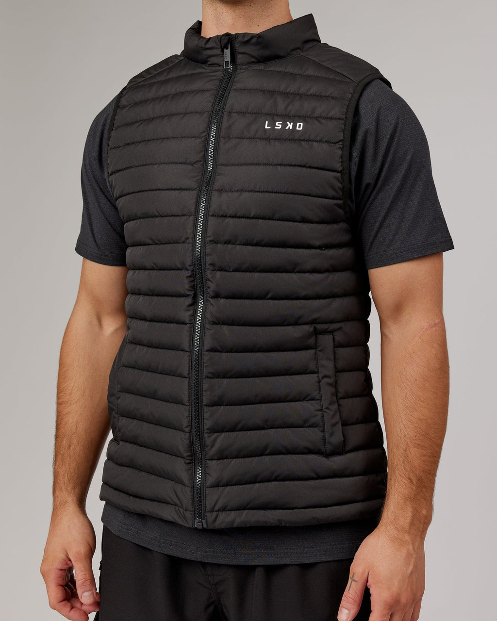 Model wearing Uplift Puffer Vest - Black Fade
