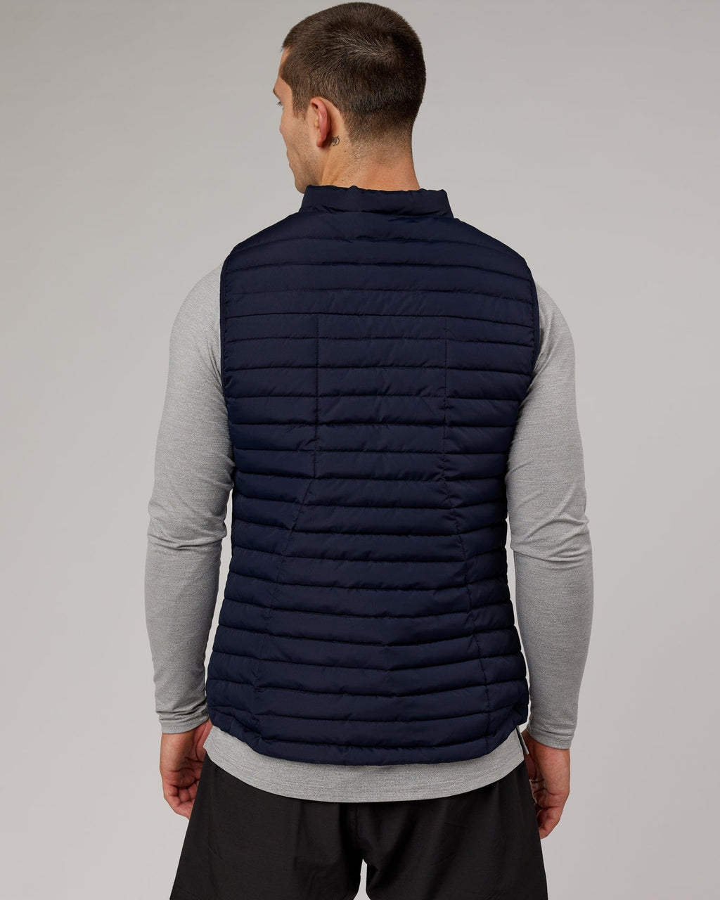 Model wearing Uplift Puffer Vest - Navy