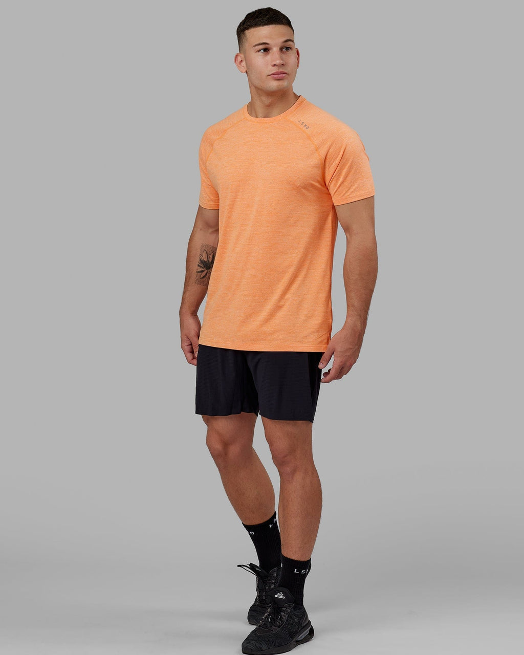 Model wearing Perform VapourFLX Tee - Tangerine Marl