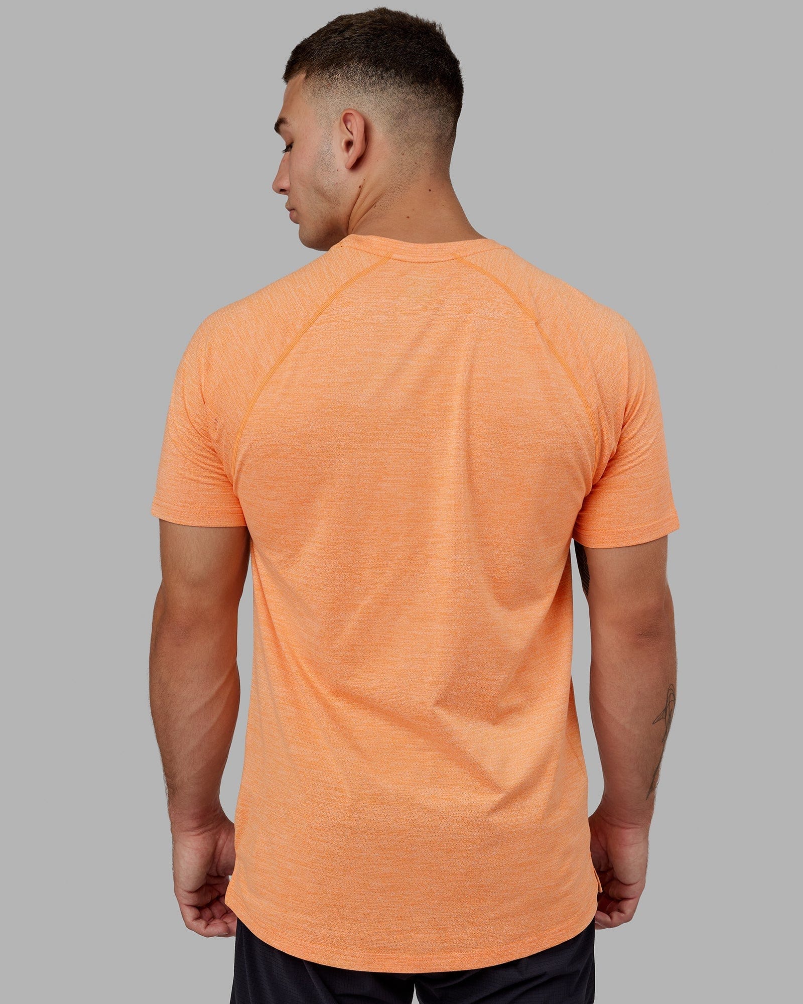 Model wearing Perform VapourFLX Tee - Tangerine Marl