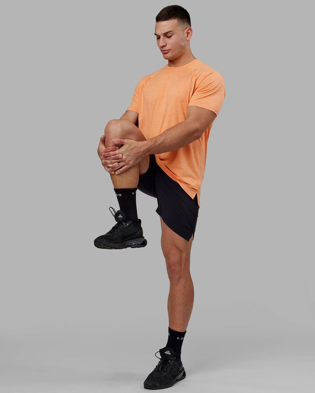Model wearing Perform VapourFLX Tee - Tangerine Marl