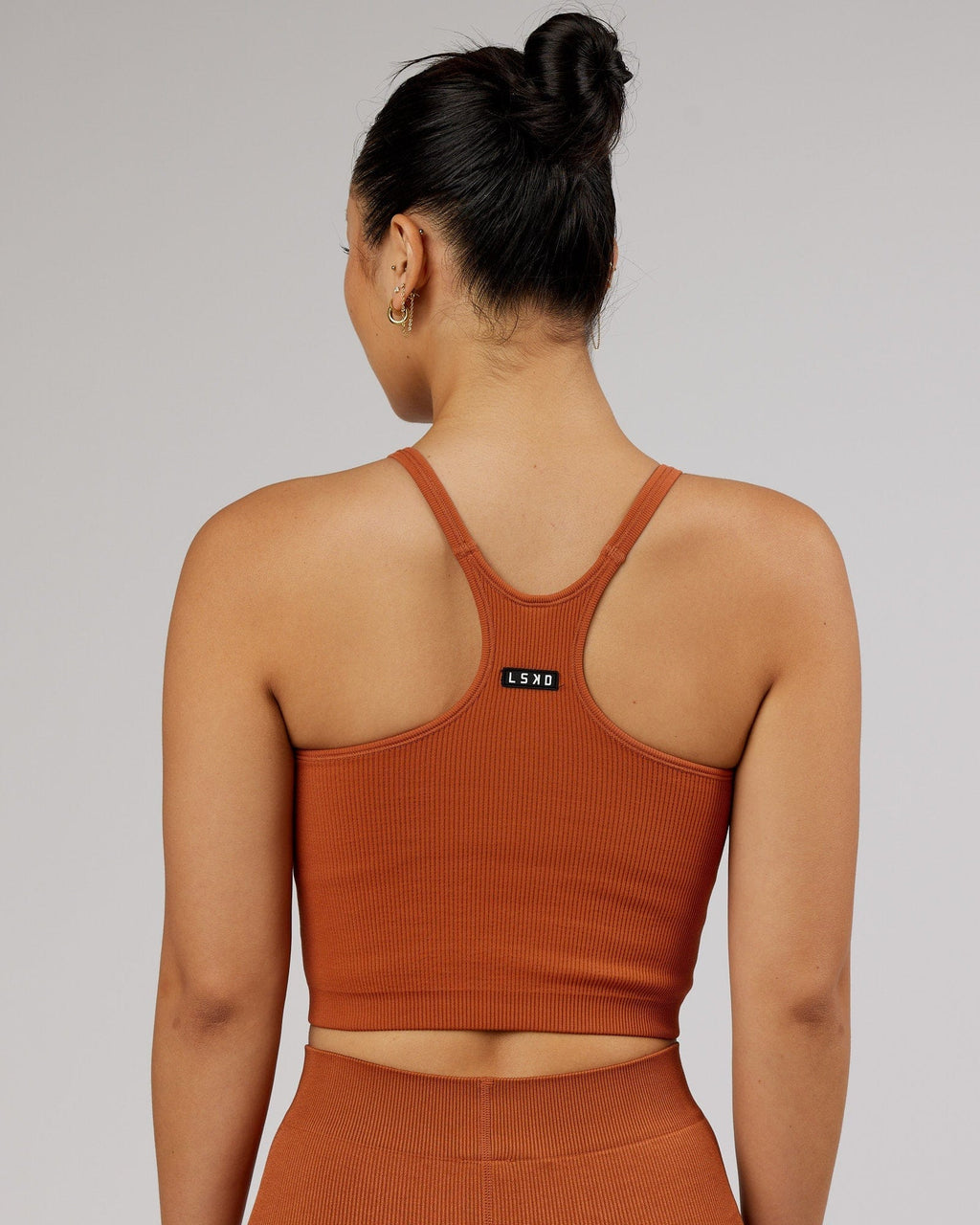 Model wearing Minimal Seamless Crop Ribbed Tank - Auburn