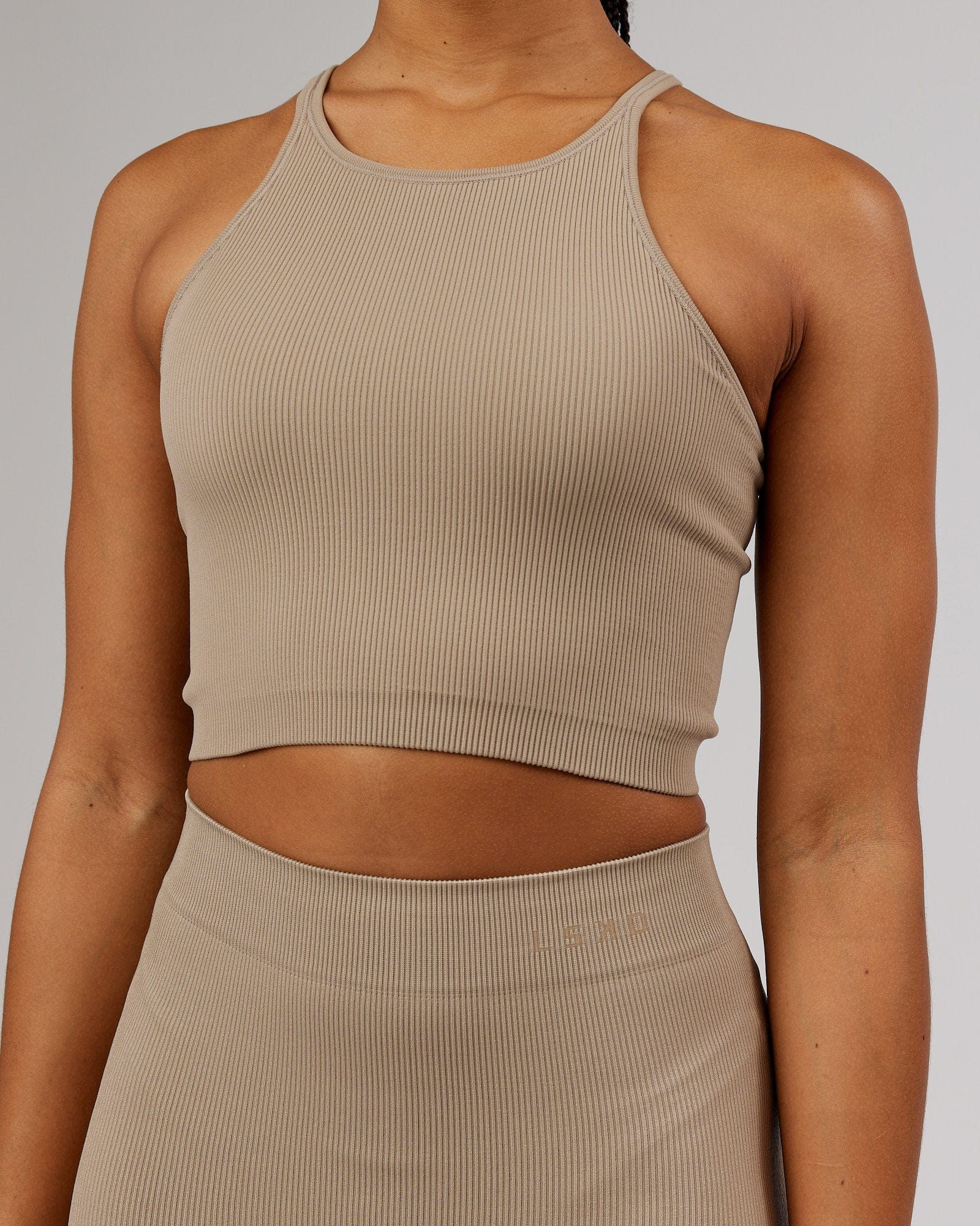 Model wearing Minimal Seamless Crop Ribbed Tank - Taupe
