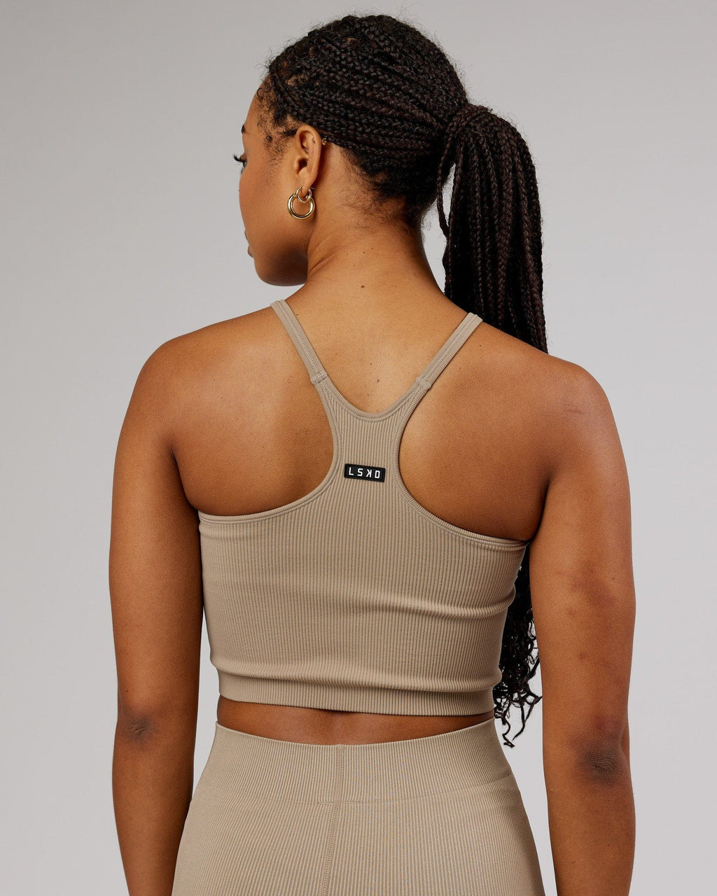 Model wearing Minimal Seamless Crop Ribbed Tank - Taupe