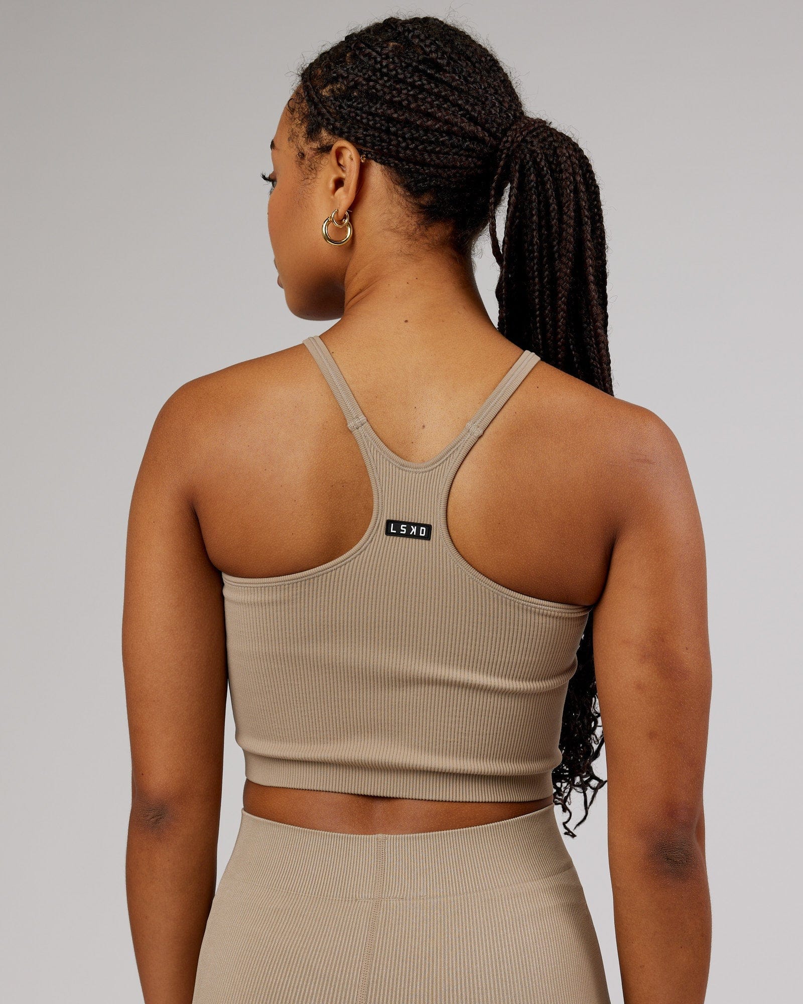 Model wearing Minimal Seamless Crop Ribbed Tank - Taupe