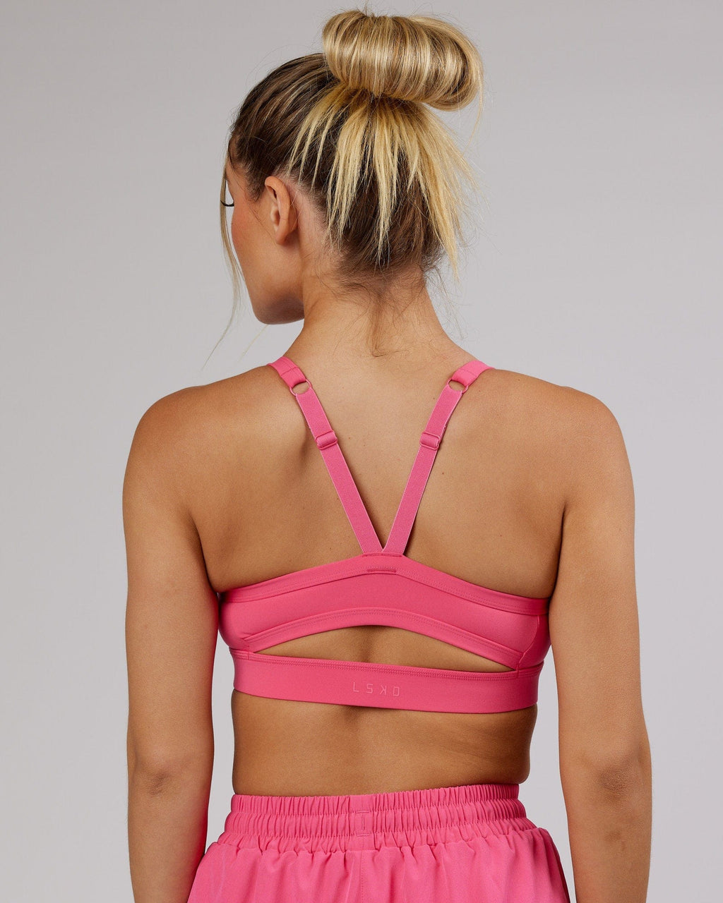Model wearing Momentum Sports Bra - Flamingo