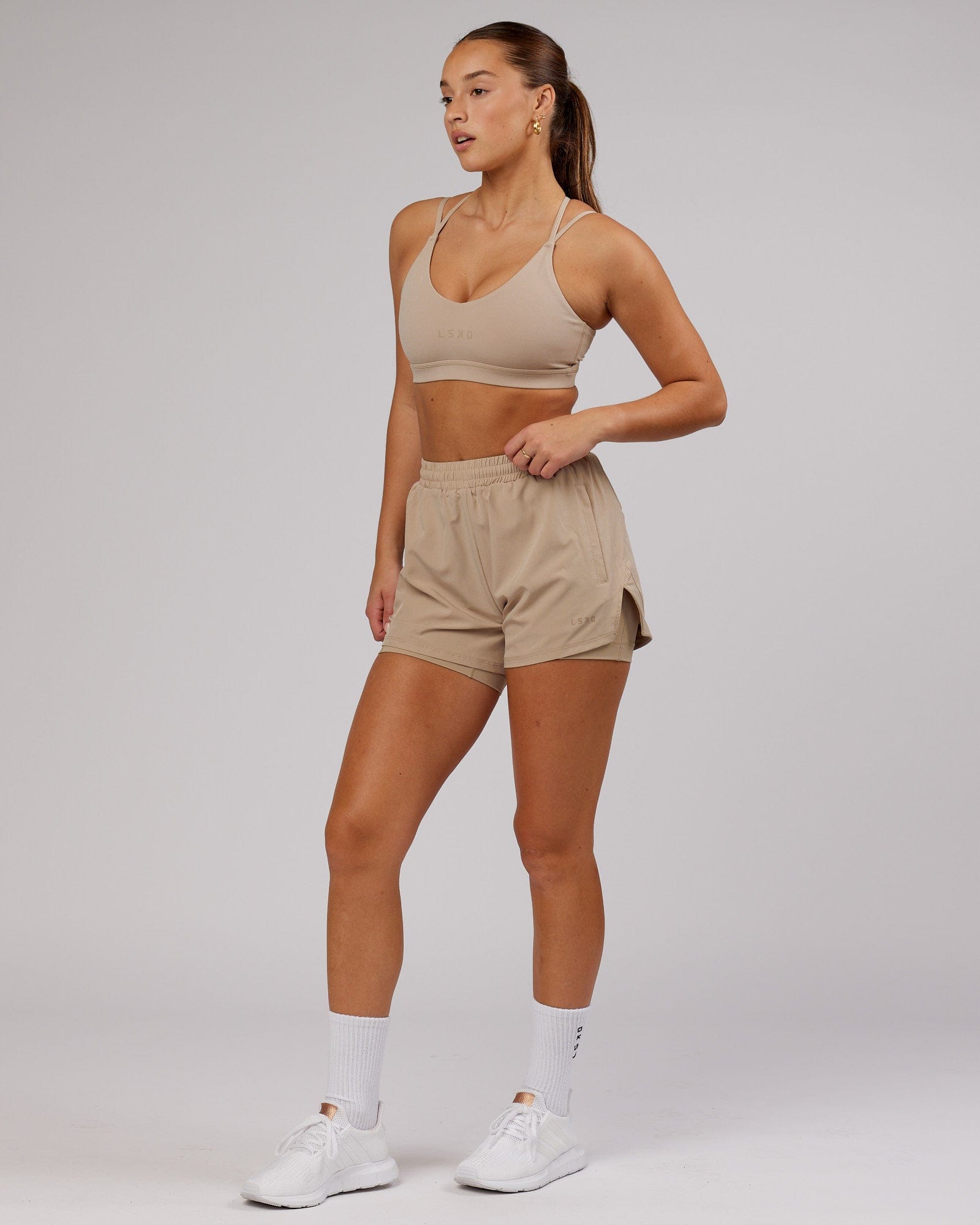 Model wearing Movement Sports Bra - Taupe