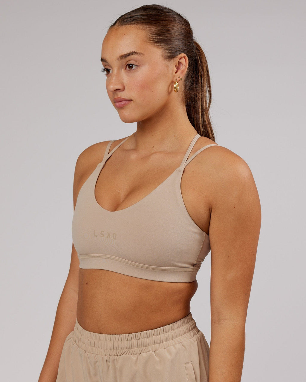 Model wearing Movement Sports Bra - Taupe