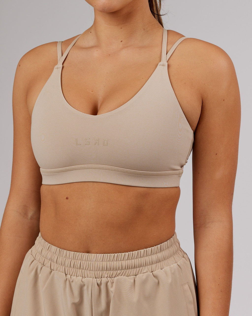 Model wearing Movement Sports Bra - Taupe